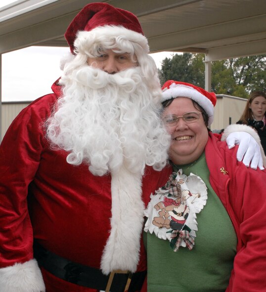 Santa Claus hugs Kathy Petty, a client of the Handicap Are Producers House, on Barksdale Air Force Base, La., Dec. 9. Petty came to the annual Christmas party for the desserts and gifts, but was especially excited to see Santa.  (U.S. Air Force photo/Airman 1st Class Joseph A. Pagán Jr.)(RELEASED)