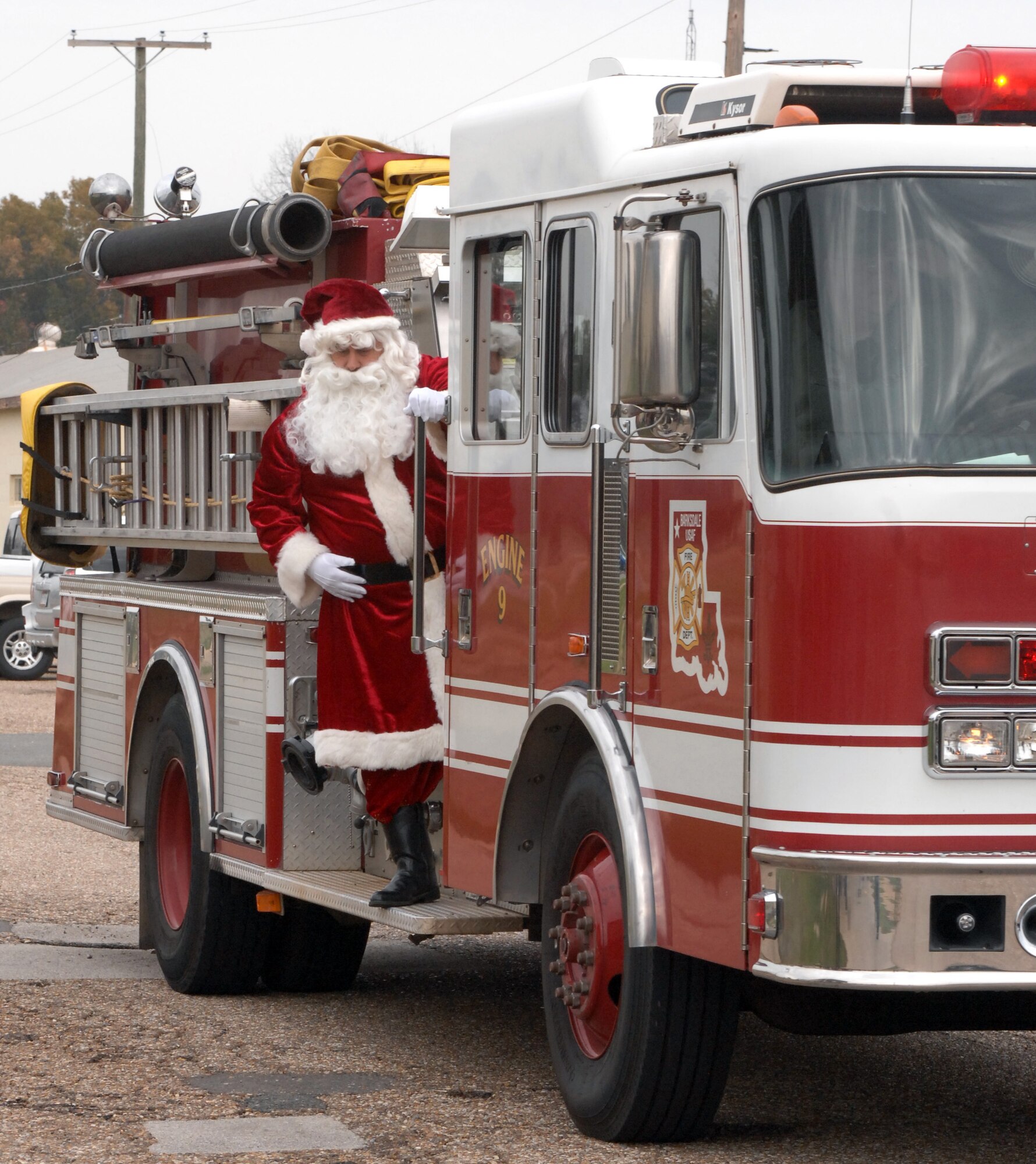 Santa Claus arrives on a fire truck at the Handicap Are Producers House on Barksdale Air Force Base, La., Dec. 9. Santa came to the annual Christmas party to hand out presents to all the clients of the HAP House. (U.S. Air Force photo/Airman 1st Class Joseph A. Pagán Jr.)(RELEASED)