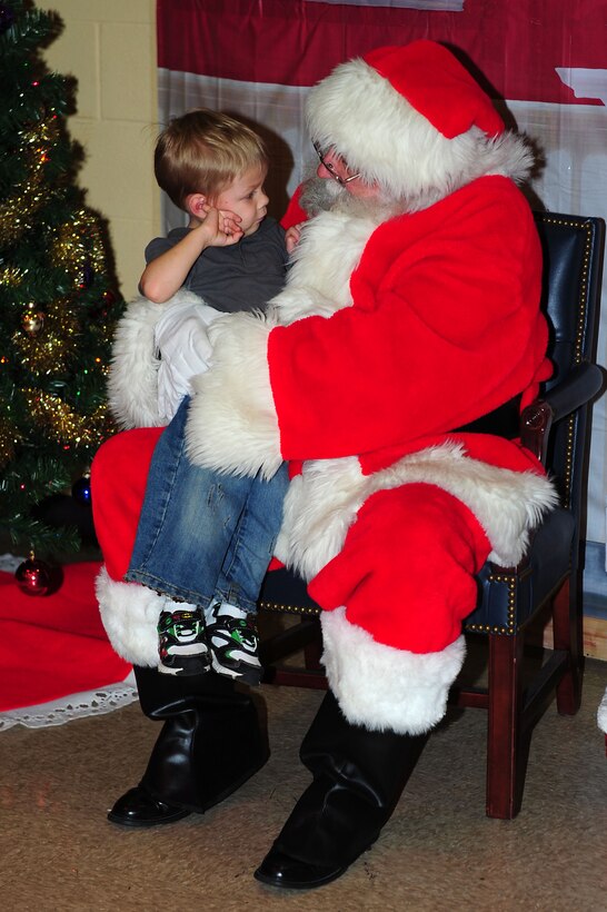 Vernon Piper Jr., son of U.S. Air Force Staff Sgt. Vernon Piper Sr., 83rd Network Operations Squadron, tells Santa Clause what he would like for Christmas during Breakfast with Santa at Langley Air Force Base, Va., Dec. 10, 2011. The annual event was hosted by the Langley Youths Program for Langley AFB dependants. (U.S. Air Force photo by Airman 1st Class Kayla Newman/Released) 