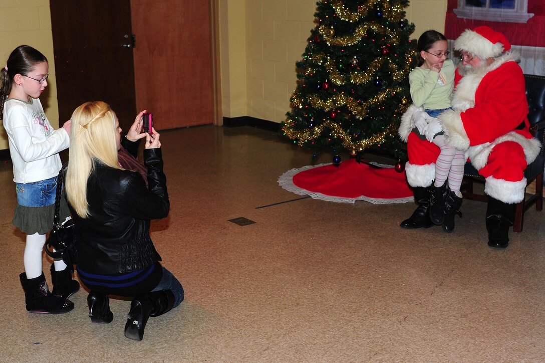 Dependants of active duty service members get the opportunity to sit on Santa Clauses lap during Breakfast with Santa at Langley Air Force Base, Va., Dec. 10, 2011.  The event also offered parents the opportunity to photograph their children with Mr. and Mrs. Clause.  (U.S. Air Force photo by Airman 1st Class Kayla Newman/Released) 