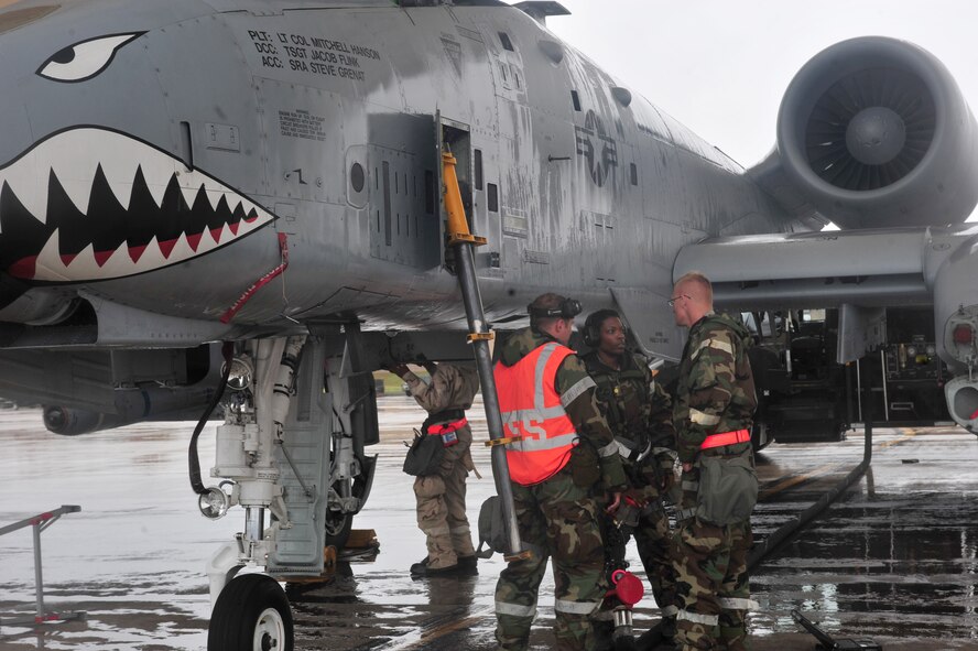 U.S. Air Force crew chiefs with the 23rd Aircraft Maintenance Squadron prepare an A-10C Thunderbolt II aircraft for refueling during a phase II operational readiness exercise at Moody Air Force Base, Ga., Dec. 7, 2011. The A-10 received maintenance, a weapons load and fuel. (U.S. Air Force photo by Staff Sgt. Stephanie Mancha/Released)
