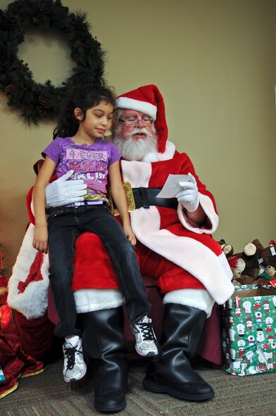 Sunethra Ruth, daughter of Senior Airman Randy Ruth, 723rd Aircraft Maintenance Squadron HH-60G Pave Hawk crew chief, shares her Christmas list with Santa Claus during the 23rd Force Support Squadron’s annual Breakfast with Santa at Moody Air Force Base, Ga., Dec. 10, 2011. Throughout the event, Santa met children and handed out gifts such as books, teddy bears and Christmas ornaments. (U.S. Air Force photo by Airman 1st Class Olivia Dominique/Released)