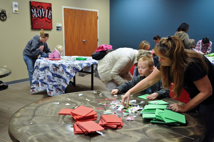 Families create Christmas decorations during the 23rd Force Support Squadron’s annual Breakfast with Santa at Moody Air Force Base, Ga., Dec. 10, 2011. This was the first time that the event was held on Moody rather than the Valdosta youth center. (U.S. Air Force photo by Airman 1st Class Olivia Dominique/Released)