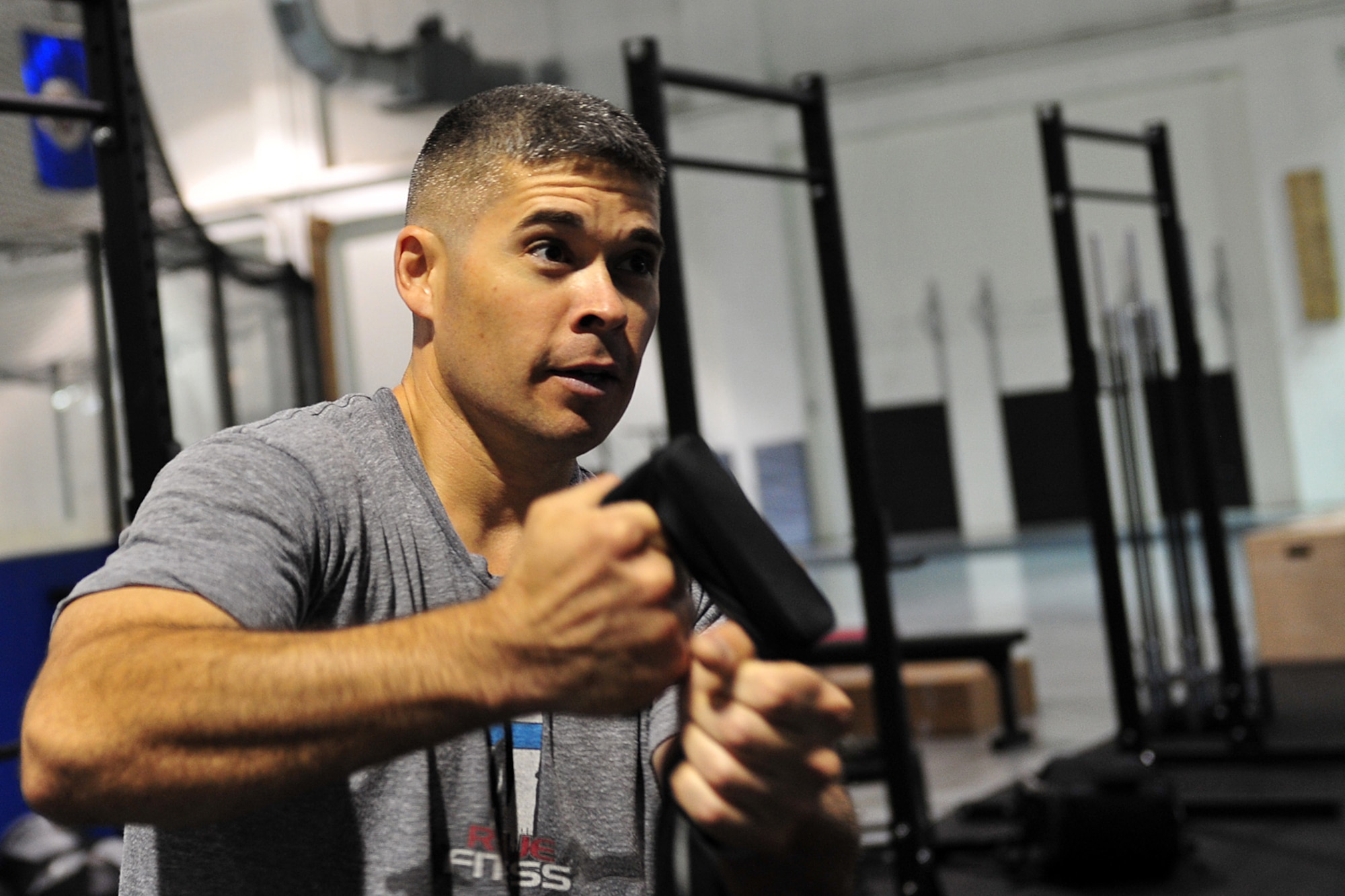 U.S. Marine Maj. Macro Serna, U.S. Strategic Command, demonstrates how the shoulder joints work while doing a push-up during the tactical fitness class in the field house on Offutt Air Force Base, Neb., Nov. 3.  Serna is one of the initial coaches for the course that will be available to Team Offutt members in January. 
(U.S. Air Force photo by Charles Haymond/Released)