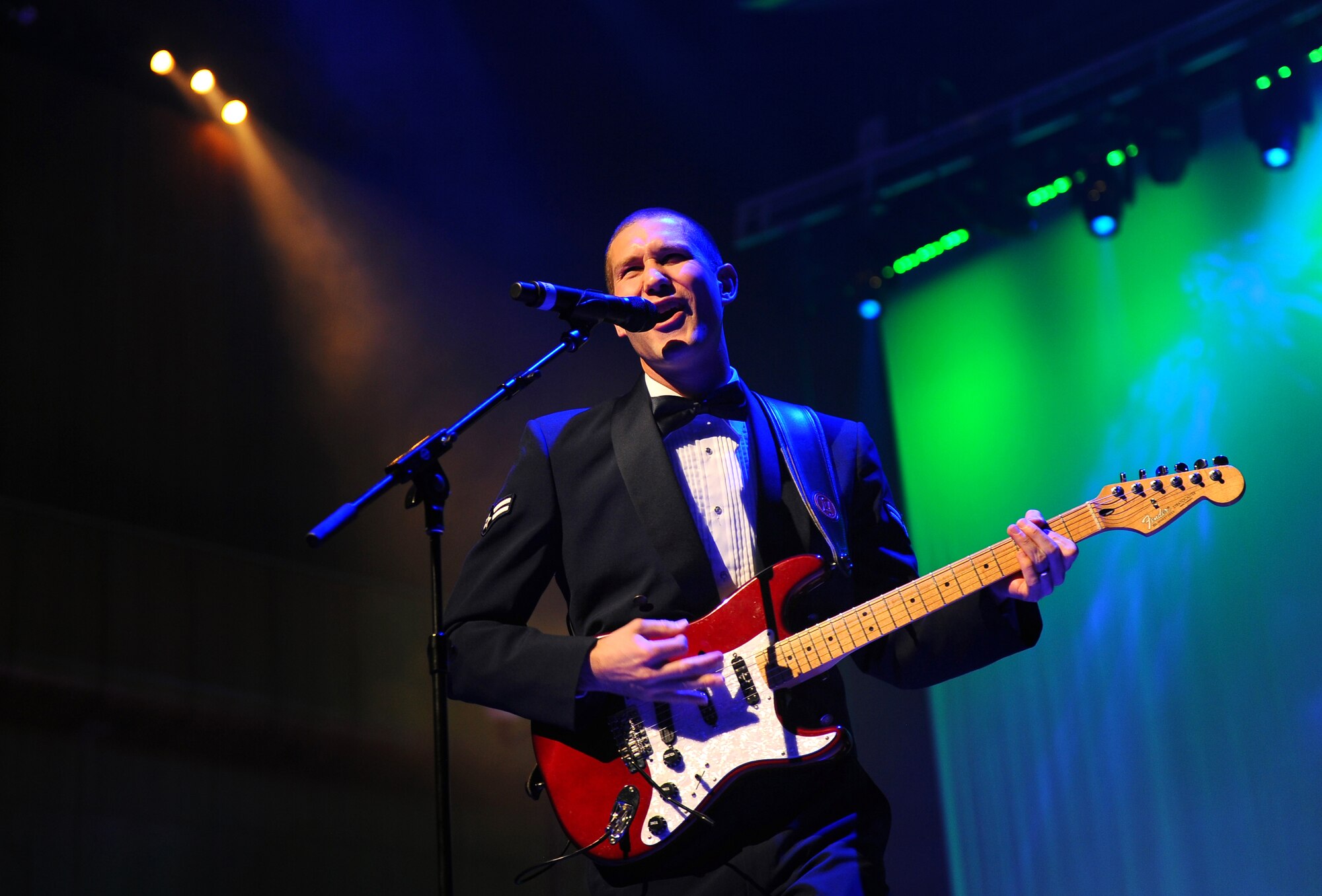 U.S. Air Force Airman 1st Class Lee Heerspink, a guitarist with the U.S. Air Force Heartland of America Band, performs at the 25th annual holiday concert held at the Holland Performing Arts Center in Omaha, Neb., Dec. 7.  The Heartland of America Band works in conjunction with the Omaha World Herald to put the concert series together each year.  (U.S. Air Force Photo by Josh Plueger/Released)