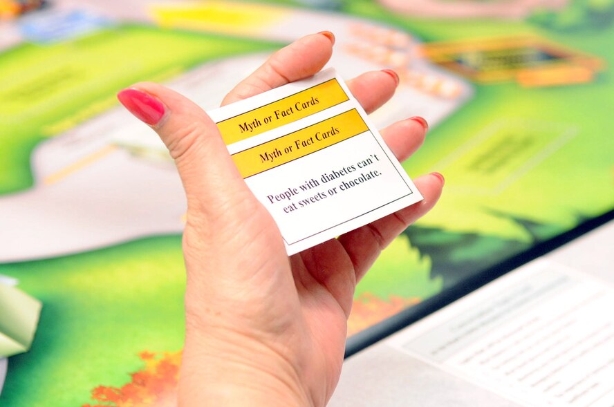 A patient reads a myth or fact Card during a diabetes class on Barksdale Air Force Base, La., Nov. 18. 'On the Road to Better Managing Your Diabetes Conversation Map,' is a board game played by patients during the two-hour class. (U.S. Air Force photo/Senior Airman La'Shanette V. Garrett)(RELEASED)