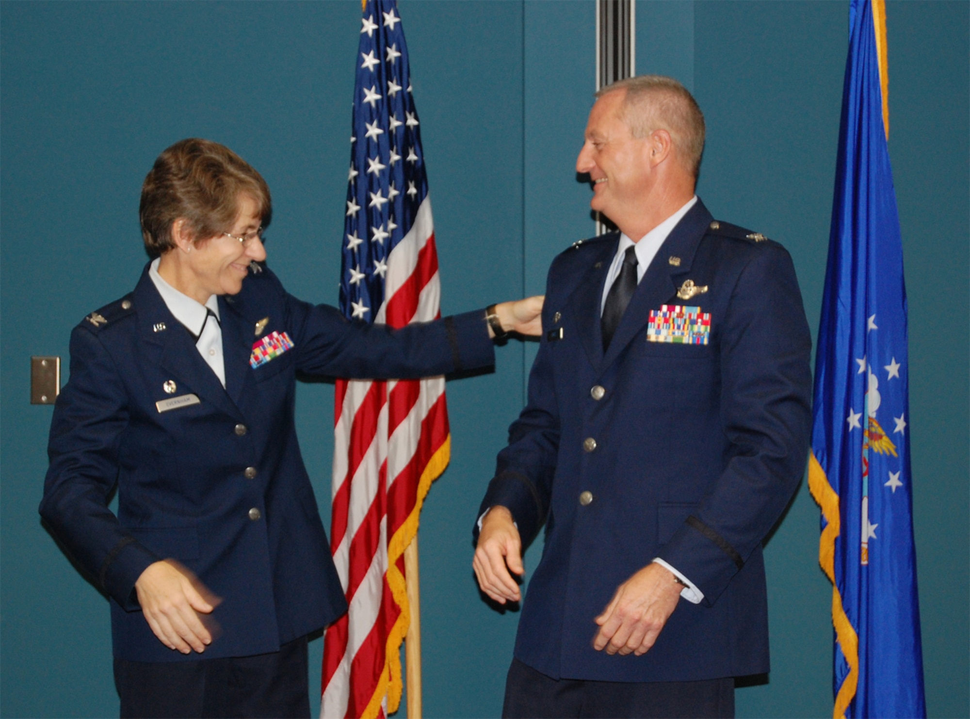 Col. Caroline Evernham, 916th Operations Group commander, joyfully tags Col. Brian S. Davis after he pins on his new rank. Col. Davis will leave the 916th as the commander of the 77th ARS bound for the ops group commander position at the Reserve wing at Andrews Air Force Base. (USAF photo by Tech. Sgt. Ian Gardner, 916OSS)