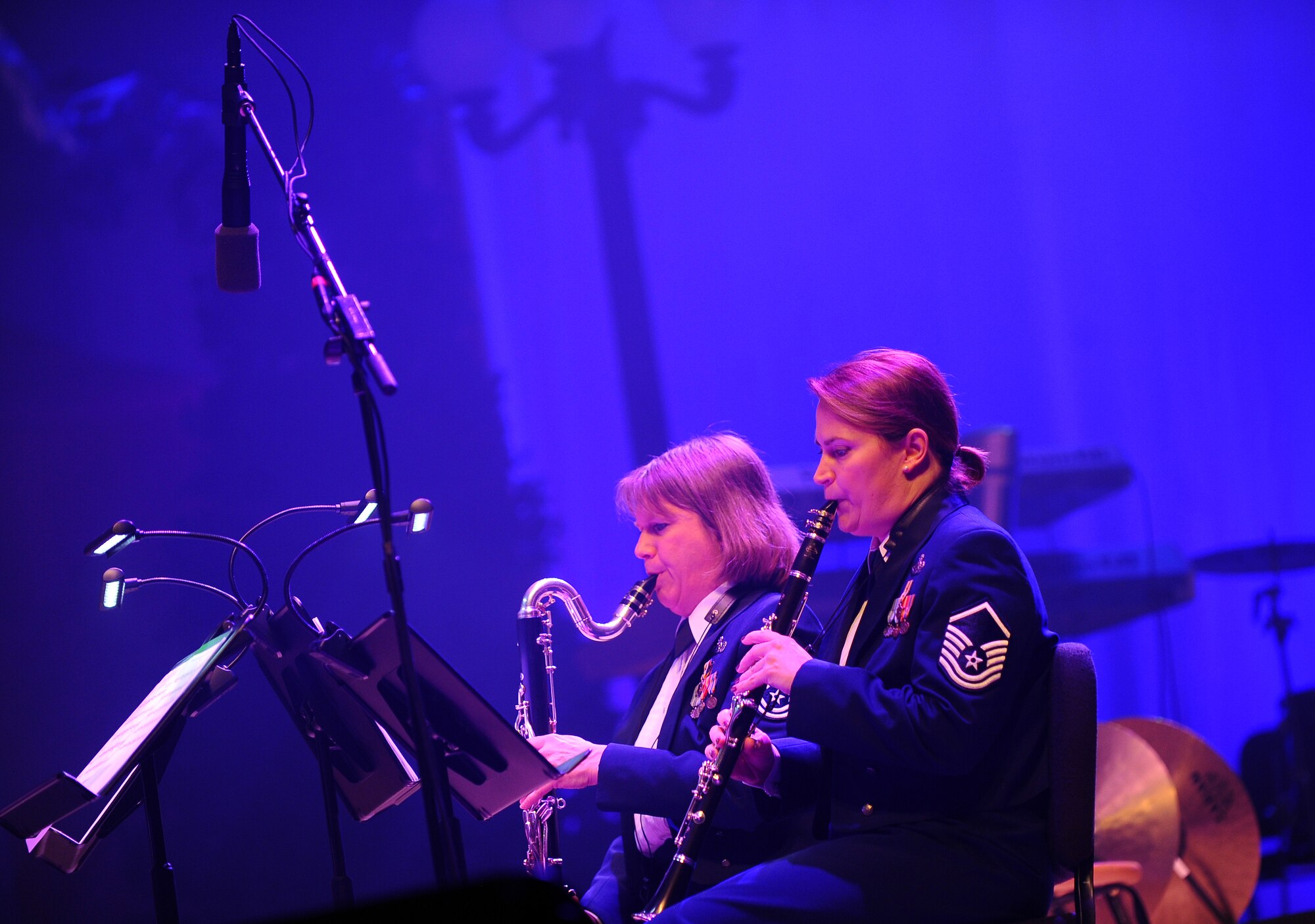 U.S. Air Force Master Sgts. Allison Baugh and Shelley Steepe, members of the U.S. Air Force Heartland of America Band, perform at the 25th annual holiday concert hosted in conjunction with the Omaha World Herald at the Holland Performing Arts Center in Omaha, Neb., Dec. 7.  The concert marked the 25th anniversary of holiday performances by the band.   (U.S. Air Force Photo by Josh Plueger/Released)