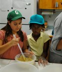 From left, Alyson Watson and Kallerston Ponder mix ingredients together for sweet treats. The Gunter Youth Center made snacks from scratch to deliver to security forces and fire department personnel. This project is one of the several projects the Gunter Youth Center conducts throughout the year. For more information about the Gunter Youth Center, call 416-3436. (Air Force photo/Christopher Kratzer)