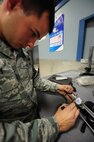 Senior Airman Mark Savoy uses a micrometer to mark where a piece of tubing will be cut on Seymour Johnson Air Force Base, N.C., Dec. 8, 2011.  After bending the tube, it is trimmed down to required specifications for use as either hydraulic or fuel lines. Savoy, 4th Equipment Maintenance Squadron aircraft structural maintenance journeyman, is a native of Riverdale, N.J. (U.S. Air Force photo by Senior Airman Rae Perry)