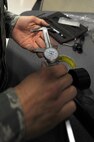 Senior Airman Mark Savoy adjusts a micrometer before measuring a piece of tubing for trimming on Seymour Johnson Air Force Base, N.C., Dec. 8, 2011. A micrometer is a tool used to make precise measurements down to thousandths of an inch. Savoy, 4th Equipment Maintenance Squadron aircraft structural maintenance journeyman, is a native of Riverdale, N.J. (U.S. Air Force photo by Senior Airman Rae Perry)