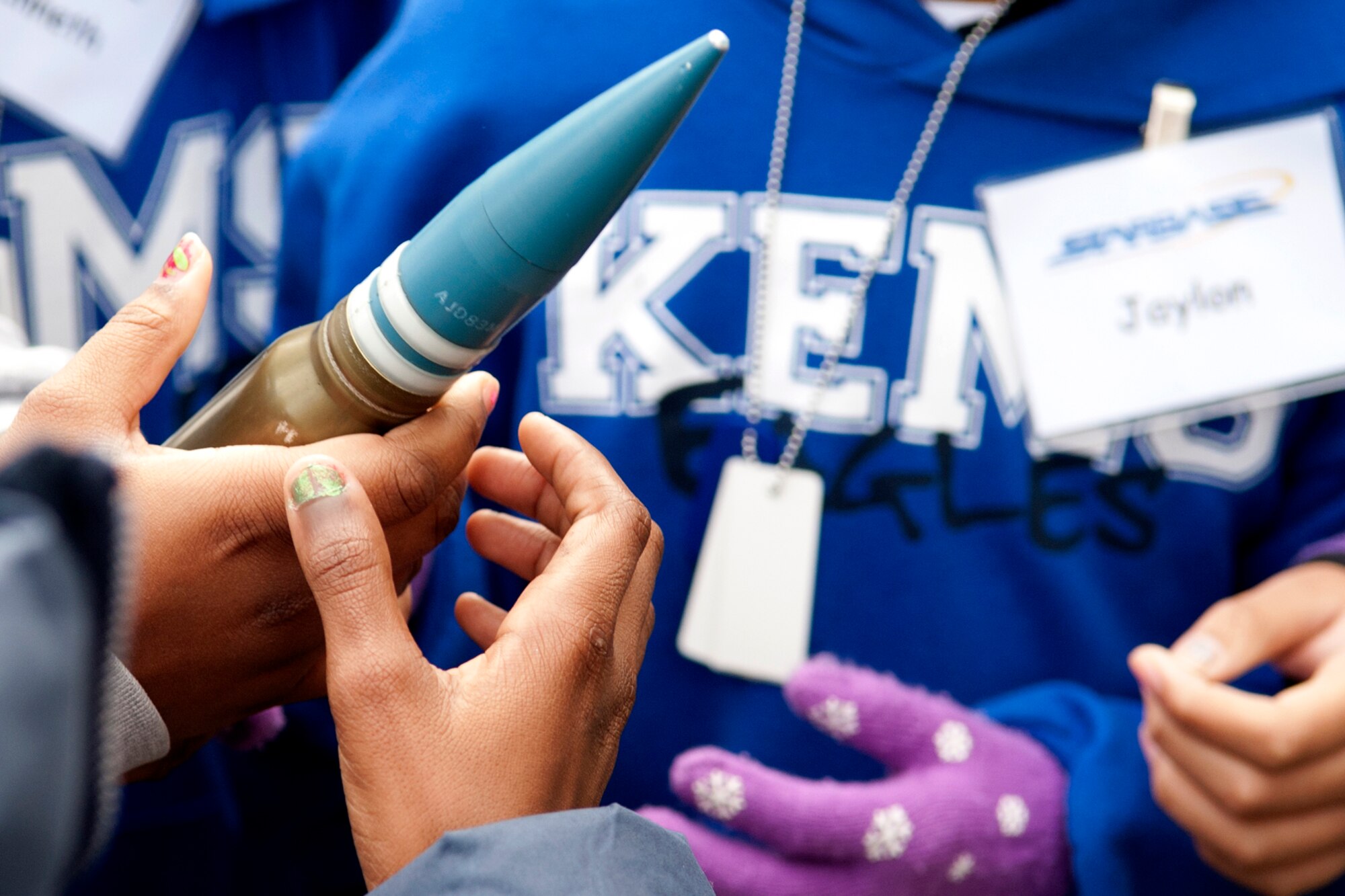 STARBASE students pass around a replica of a 30 millimeter bullet during a tour of an A-10 Thunderbolt II, Barksdale Air Force Base, La., Dec. 9, 2011. STARBASE is a premiere educational program, sponsored by the Office of the Assistant Secretary of Defense for Reserve Affairs. (U.S. Air Force photo by Master Sgt. Greg Steele/Released)
