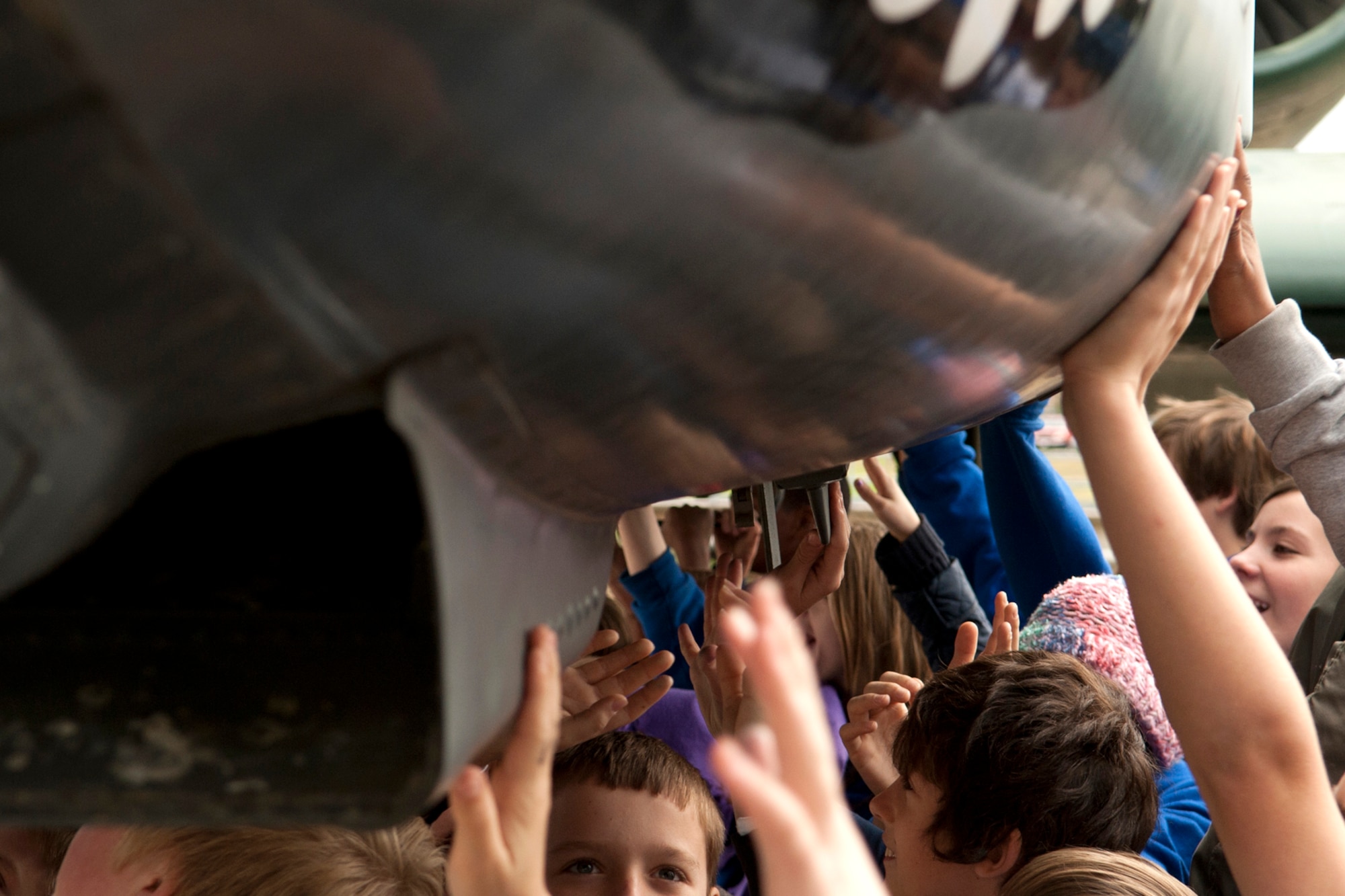 STARBASE students touch an A-10 Thunderbolt II during a tour at Barksdale Air Force Base, La., Dec. 9, 2011. STARBASE students participate in challenging "hands-on, minds-on" activities in Science, Technology, Engineering, and Math. (U.S. Air Force photo by Master Sgt. Greg Steele/Released)