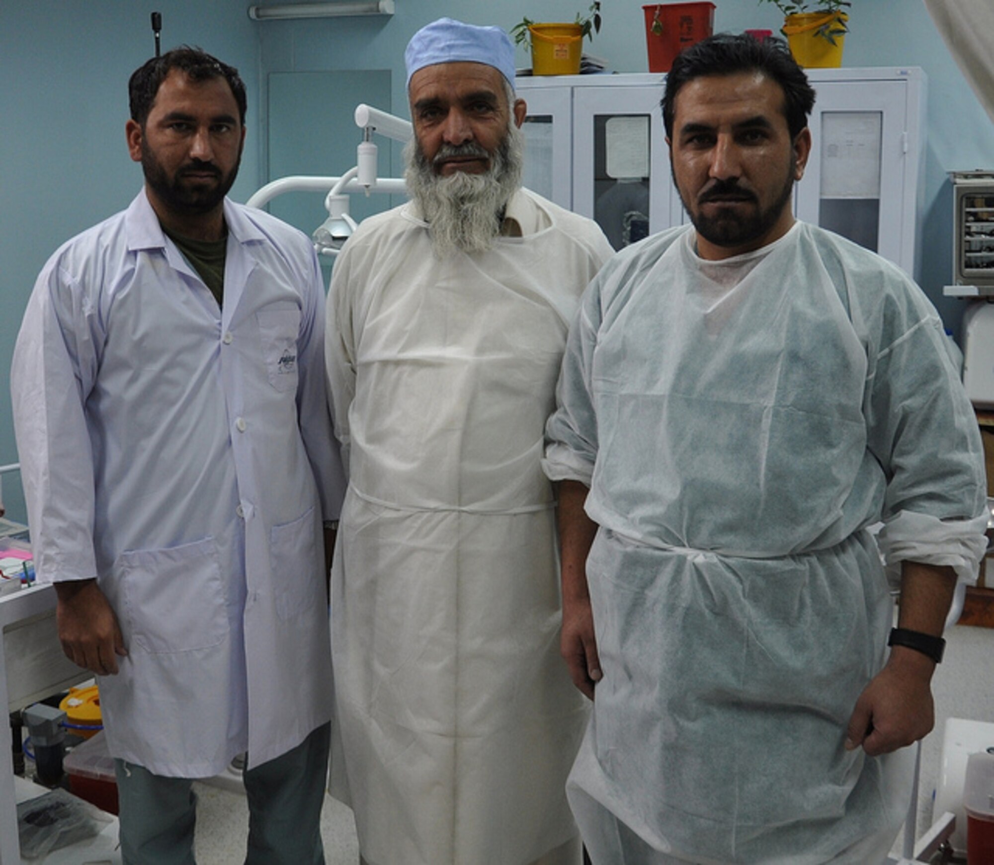 The Paktia Regional Military Hospital dental team poses for a picture Dec. 1, 2011, at Gardez Fire Base, Afghanistan. Nasir, Dost and Jant just received their first adviser, Maj. Courtney Schapira. (U.S. Air Force photo/Staff Sgt. Sarah Martinez/RELEASED)
