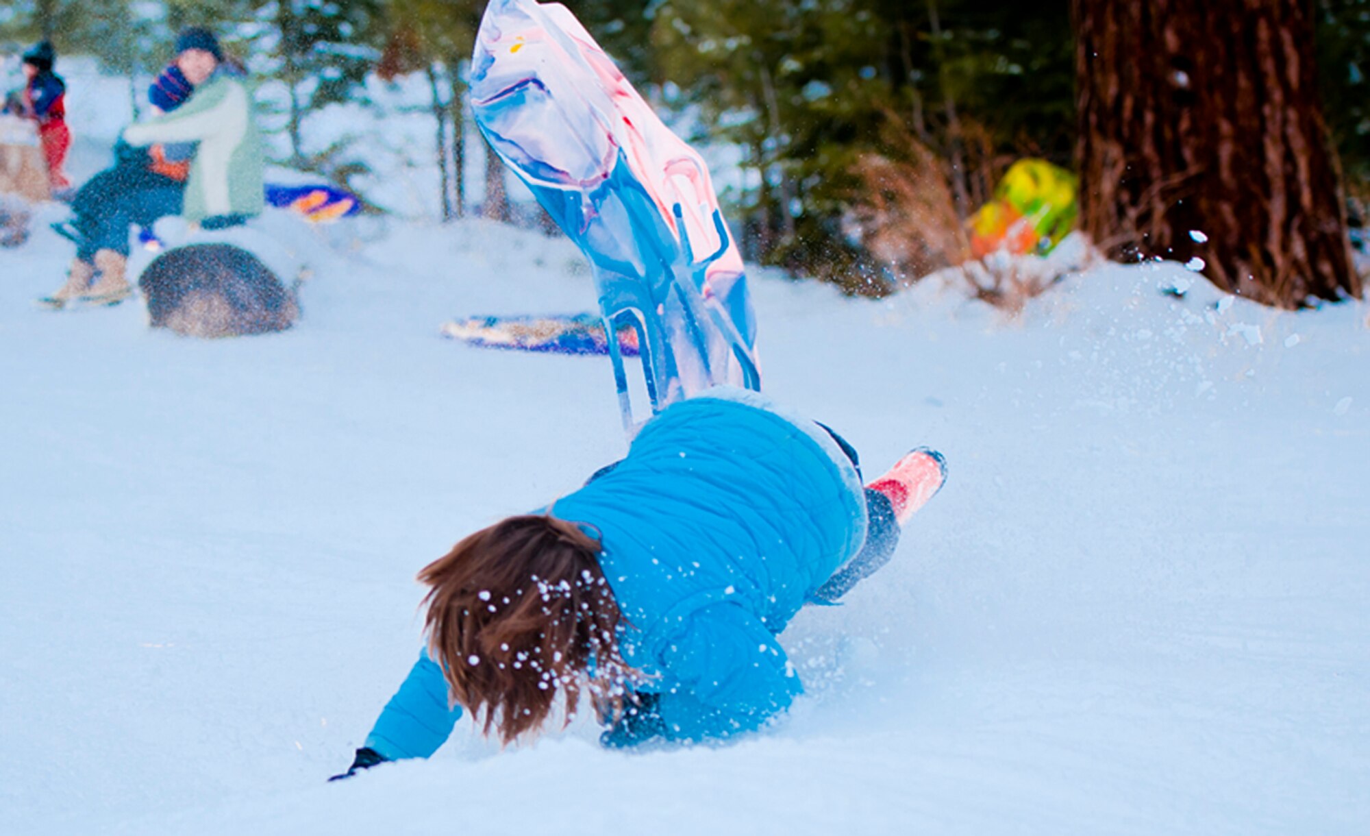 ALTERNATE ENDINGS: Sliding downhill is an exhilarating winter sport. People of all ages can participate, and use all kinds of containers, from large toboggans to plastic disks or even cardboard boxes. But accidental injuries from sledding are surprisingly common despite snow’s cushioning effect. (Photo by Tech. Sgt. Samuel Bendet)