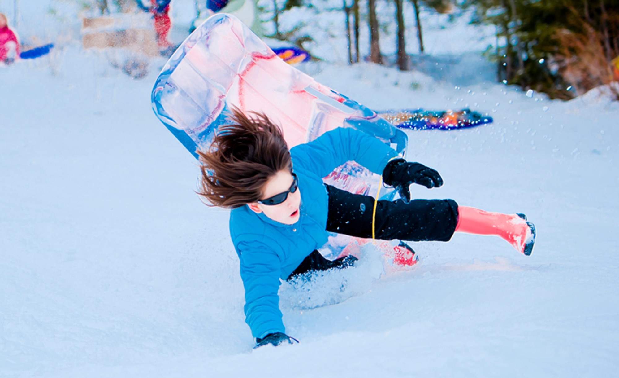 ALTERNATE ENDINGS: Sliding downhill is an exhilarating winter sport. People of all ages can participate, and use all kinds of containers, from large toboggans to plastic disks or even cardboard boxes. But accidental injuries from sledding are surprisingly common despite snow’s cushioning effect. (Photo by Tech. Sgt. Samuel Bendet)