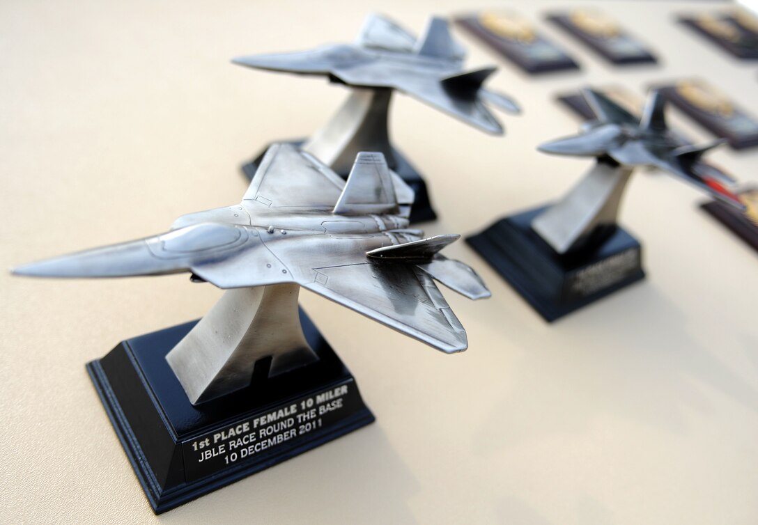 Awards for the “Race ‘Round the Base” are displayed at Langley Air Force Base, Va., Dec. 10, 2011. Trophies were given to the fastest  5-kilometer and 10-mile male and female runners of the race, and plaques given for winners of each age group. (U.S. Air Force photo by Airman 1st Class Teresa Cleveland/Released)