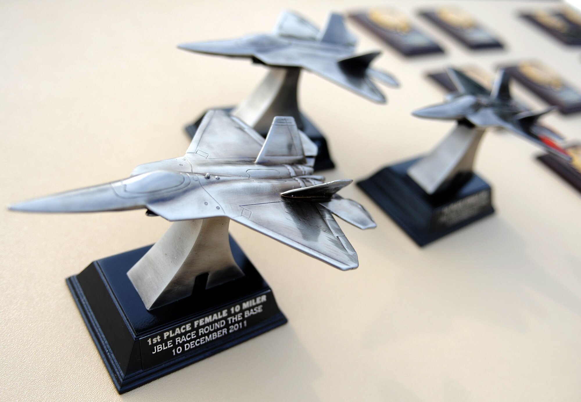 Awards for the “Race ‘Round the Base” are displayed at Langley Air Force Base, Va., Dec. 10, 2011. Trophies were given to the fastest  5-kilometer and 10-mile male and female runners of the race, and plaques given for winners of each age group. (U.S. Air Force photo by Airman 1st Class Teresa Cleveland/Released)