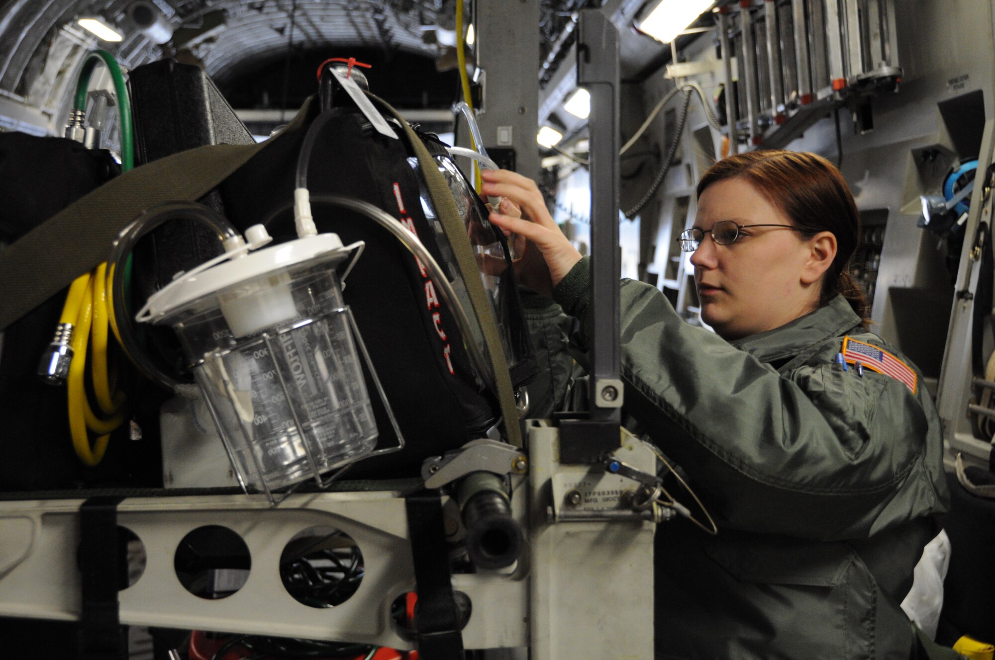 1st Lt. Megan Lange function checks a portable suction unit aboard a C-17 Globemaster III aircraft Dec. 10, 2011 at Joint Base Charleston, S.C. Lieutenant Lange is a flight nurse with the 315th Aeromedical Evacuation Squadron at JBC, and she is trained and equipped to provide in-flight medical care aboard the C-17 Globemaster III and other mission directed aircraft. (U.S. Air Force photo/Staff Sgt. Shane Ellis)  