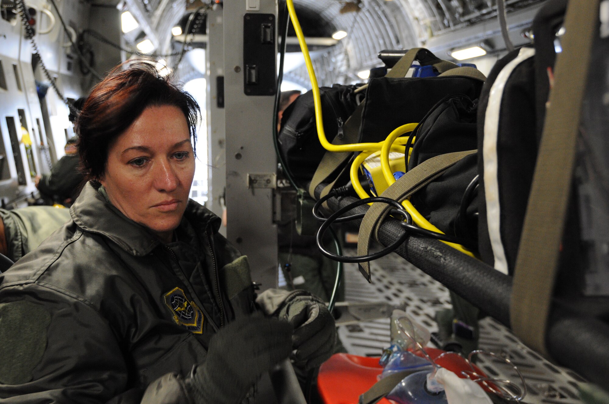 Capt. Dinah Lewis function checks a litter configuration aboard a C-17 Globemaster III aircraft Dec. 10, 2011 at Joint Base Charleston, S.C. Captain Lewis is a flight nurse with the 315th Aeromedical Evacuation Squadron at JBC, and she is trained and equipped to provide in-flight medical care aboard the C-17 Globemaster III and other mission directed aircraft. (U.S. Air Force photo/Staff Sgt. Shane Ellis)  