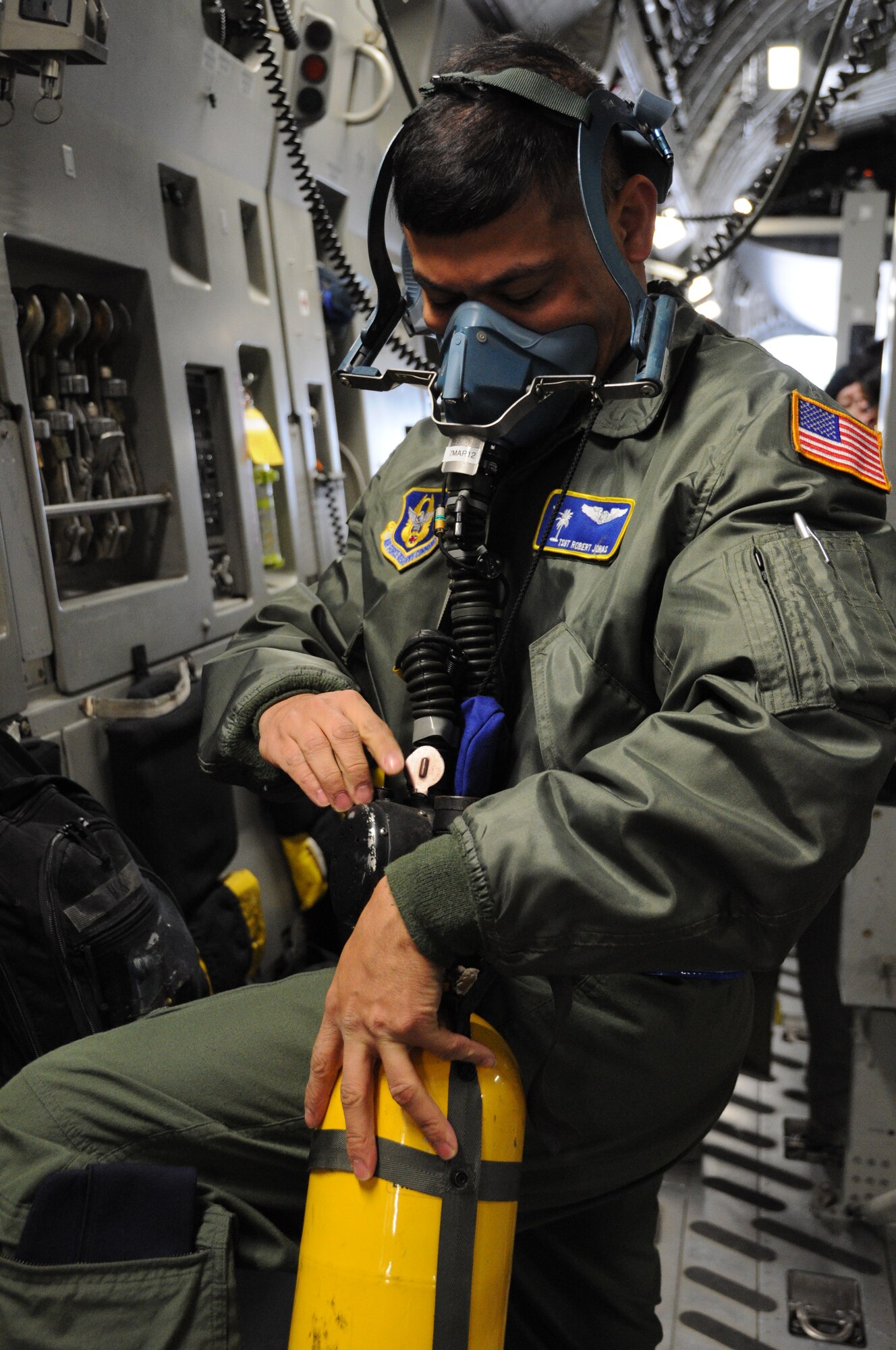 Tech. Sgt. Robert Jonas function checks an emergency oxygen mask Dec. 10, 2011 at Joint Base Charleston, S.C. Sergeant Jonas is a medical technician with the 315th Aeromedical Evacuation Squadron at JBC, and he is trained and equipped to provide in-flight medical care aboard the C-17 Globemaster III and other mission directed aircraft. (U.S. Air Force photo/Staff Sgt. Shane Ellis)  