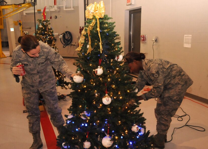 Airmen from the 916th Maintenance Group decorate their tree in honor of fallen service members. The trees were on display during the December Commander's Call. (USAF photo by Senior Airman Meredith Thomas, 916ARW/PA)