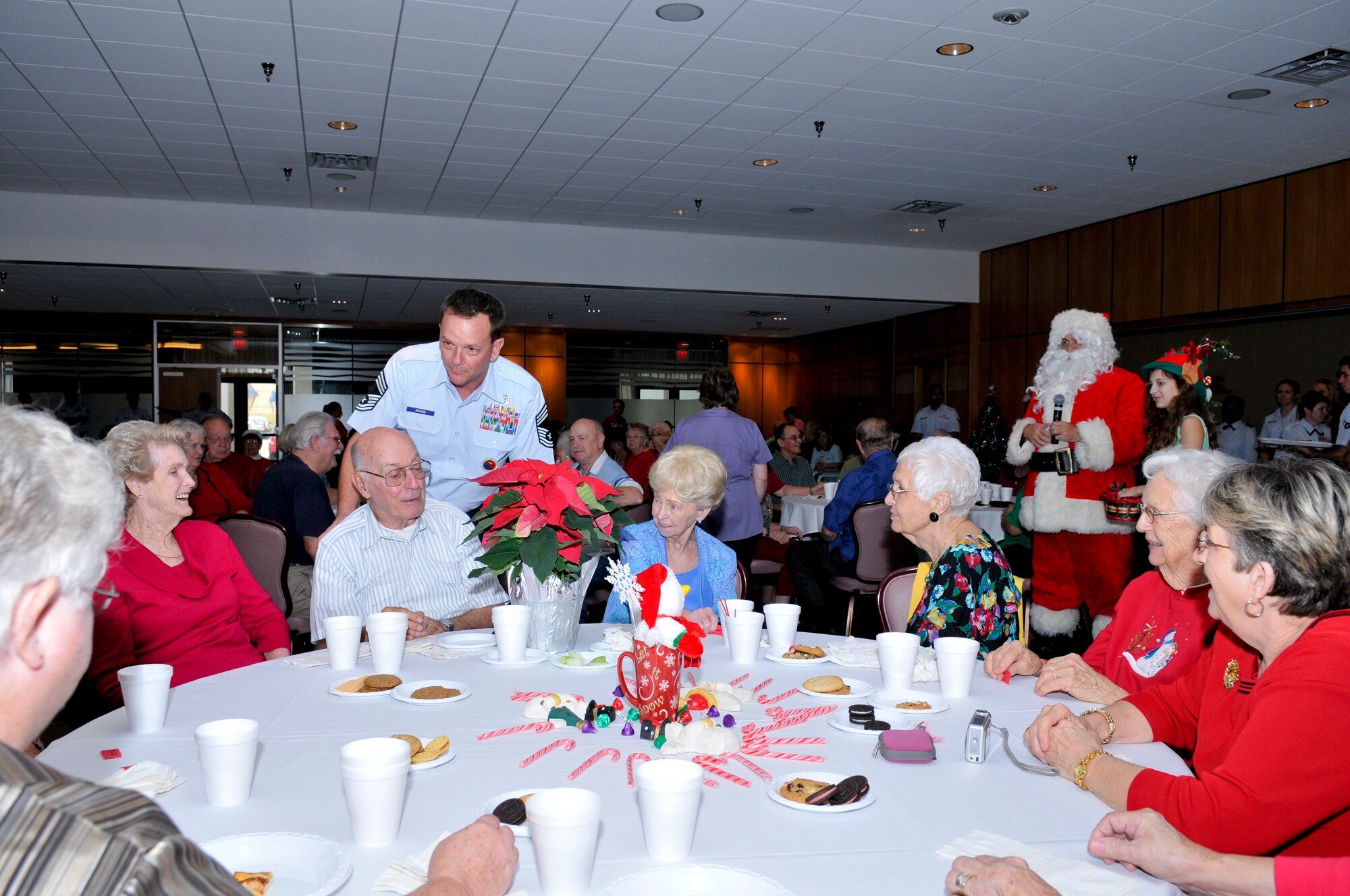 Chief Master Sgt. Malcolm McVicar greets guests at the 25th Golden Age Holiday Christmas Party hosted by the Tyndall Chief's Association at the Horizon Community Center Dec. 6.  