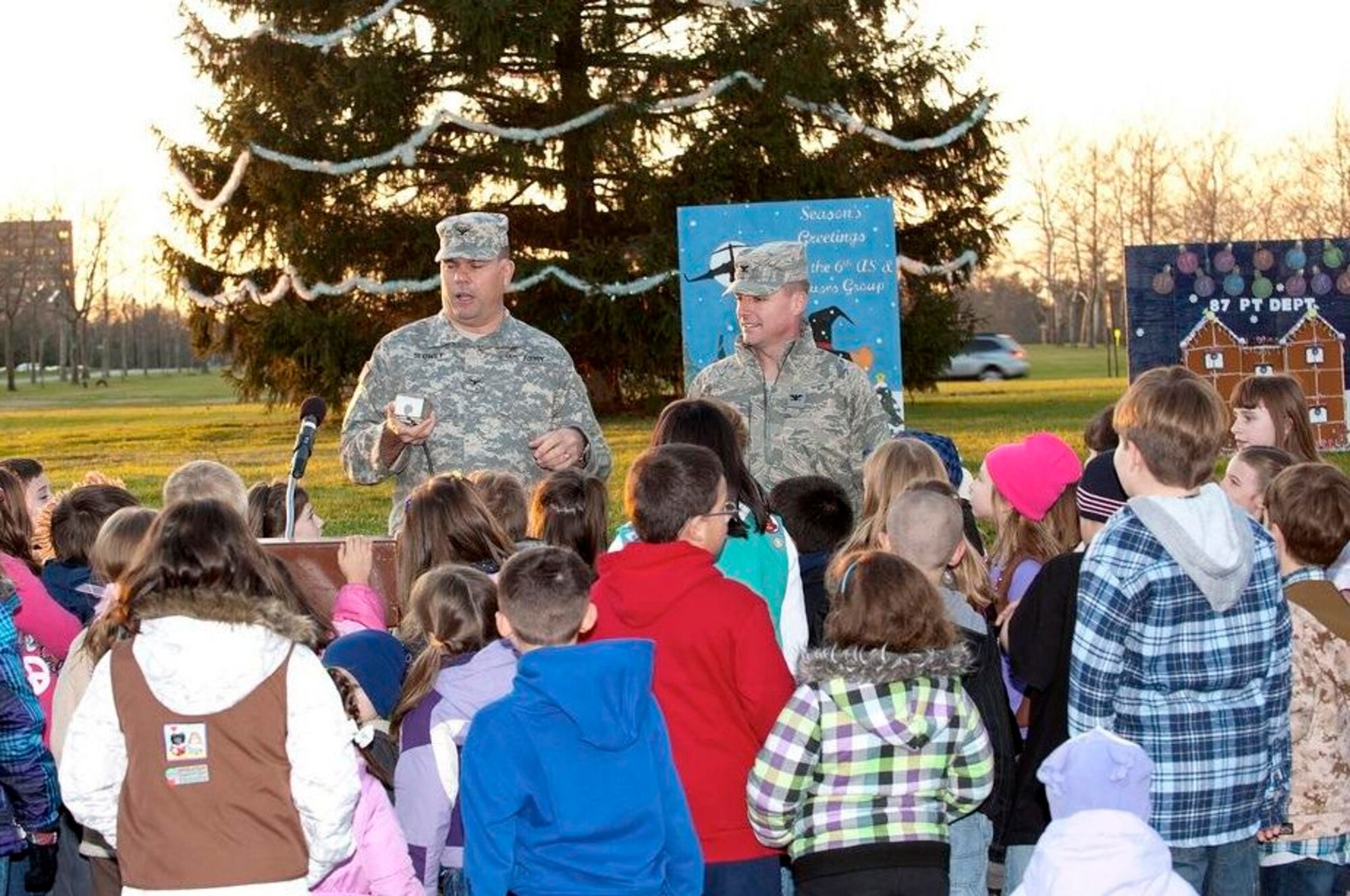 Army Support Activity-Dix Commander Col. Patrick Slowey (left), along with Col. John Wood, Joint Base McGuire-Dix-Lakehurst and 87th Air Base Wing commander, count down the official lighting of the Christmas tree in front of Wurman Hall Dec. 2 here. Large holiday cards, created by various units on base, were on display at the McGuire/Dix tree lighting ceremony as part of the holiday card contest. (U.S. Air Force Photo by Russ Meseroll/Released)