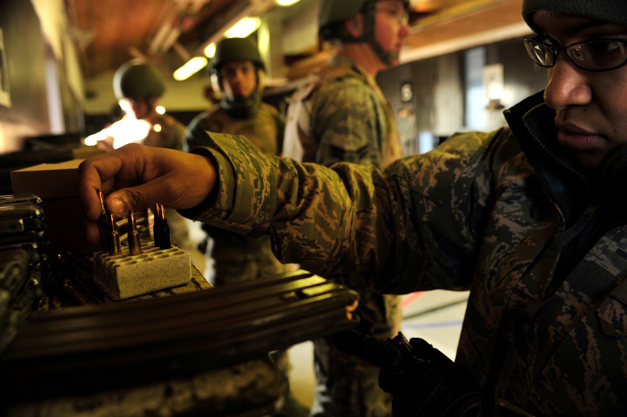 MINOT AIR FORCE BASE, N.D. – Staff Sgt. Yerida Vazquez, 5th Security Forces Squadron combat arms training and maintenance instructor, prepares M-4 magazines for a shooting qualifications class here, Dec. 8. CATM instructors are security forces personnel who train military members on weapon use. They also maintain and repair weapons in the security forces inventory. (U.S. Air Force photo/Senior Airman Desiree Esposito)