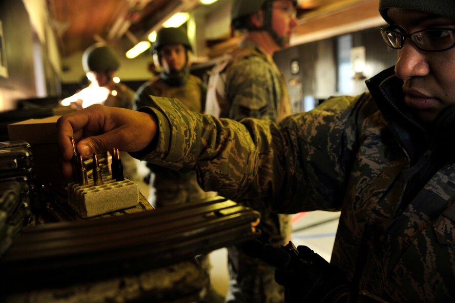 MINOT AIR FORCE BASE, N.D. – Staff Sgt. Yerida Vazquez, 5th Security Forces Squadron combat arms training and maintenance instructor, prepares M-4 magazines for a shooting qualifications class here, Dec. 8. CATM instructors are security forces personnel who train military members on weapon use. They also maintain and repair weapons in the security forces inventory. (U.S. Air Force photo/Senior Airman Desiree Esposito)