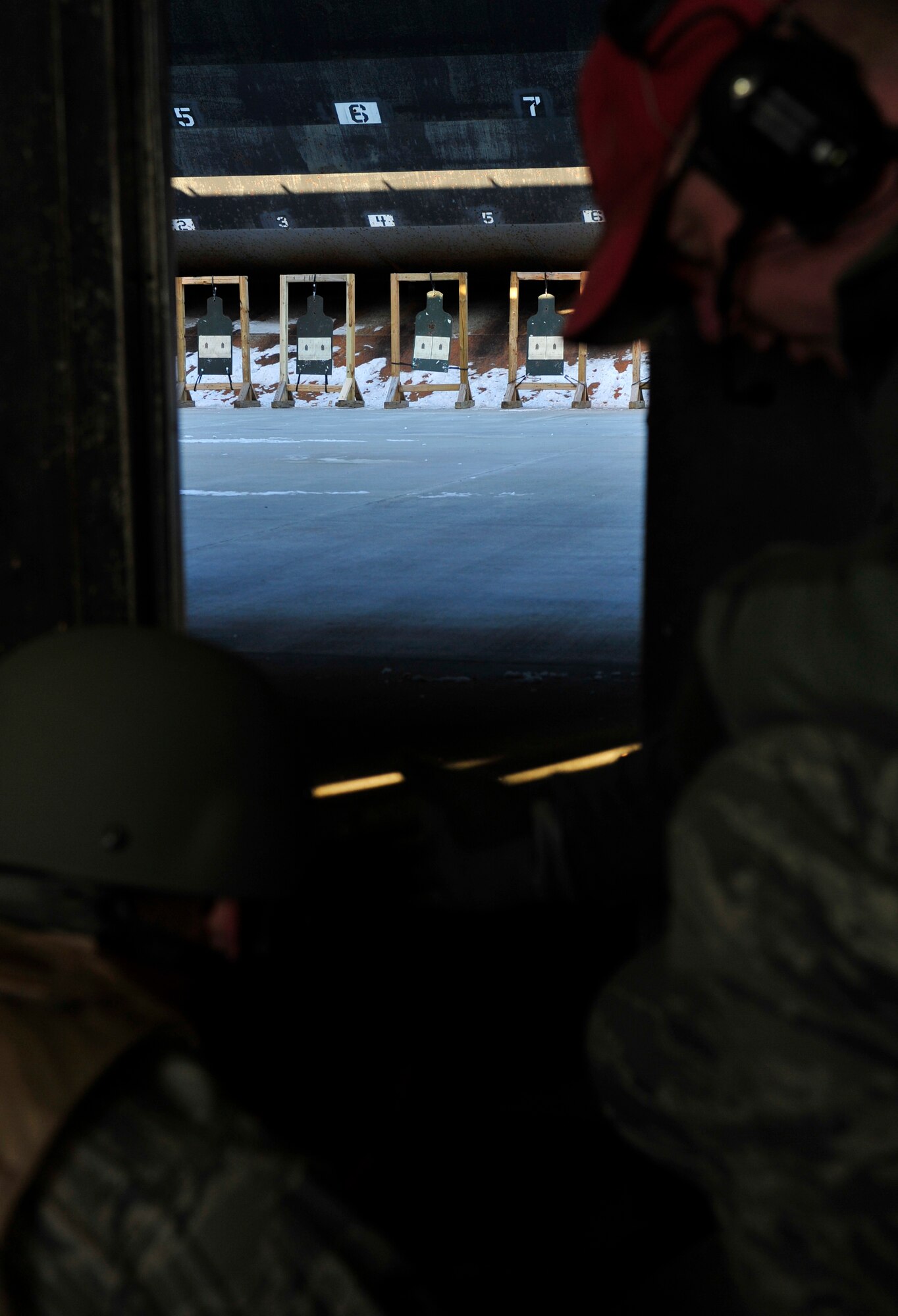MINOT AIR FORCE BASE, N.D. – Staff Sgt. Joseph Haller, 5th Security Forces Squadron combat arms training and maintenance instructor, trains Airman 1st Class John Nelson, 5th Civil Engineer Squadron power production apprentice, on qualifying firing procedures here, Dec. 8. CATM instructors are security forces personnel who train military members on weapon use. They also maintain and repair weapons in the security forces inventory. (U.S. Air Force photo/Senior Airman Desiree Esposito)