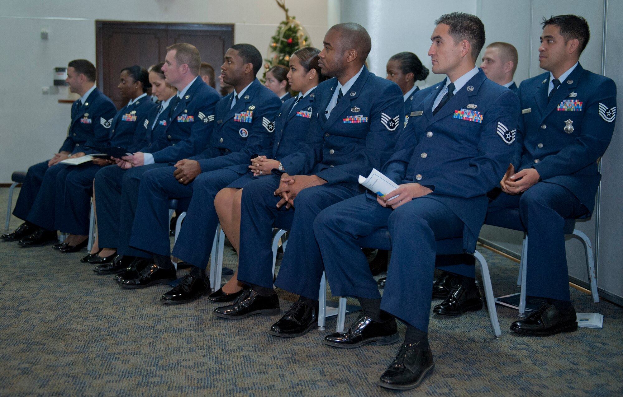 Airmen sit after receiving their Community College of the Air Force degree in their respective career fields Dec. 12, 2011, at Incirlik Air Base, Turkey. Seventeen Airmen received their degrees during the graduation. (U.S. Air Force photo by Senior Airman Anthony Sanchelli/Released)