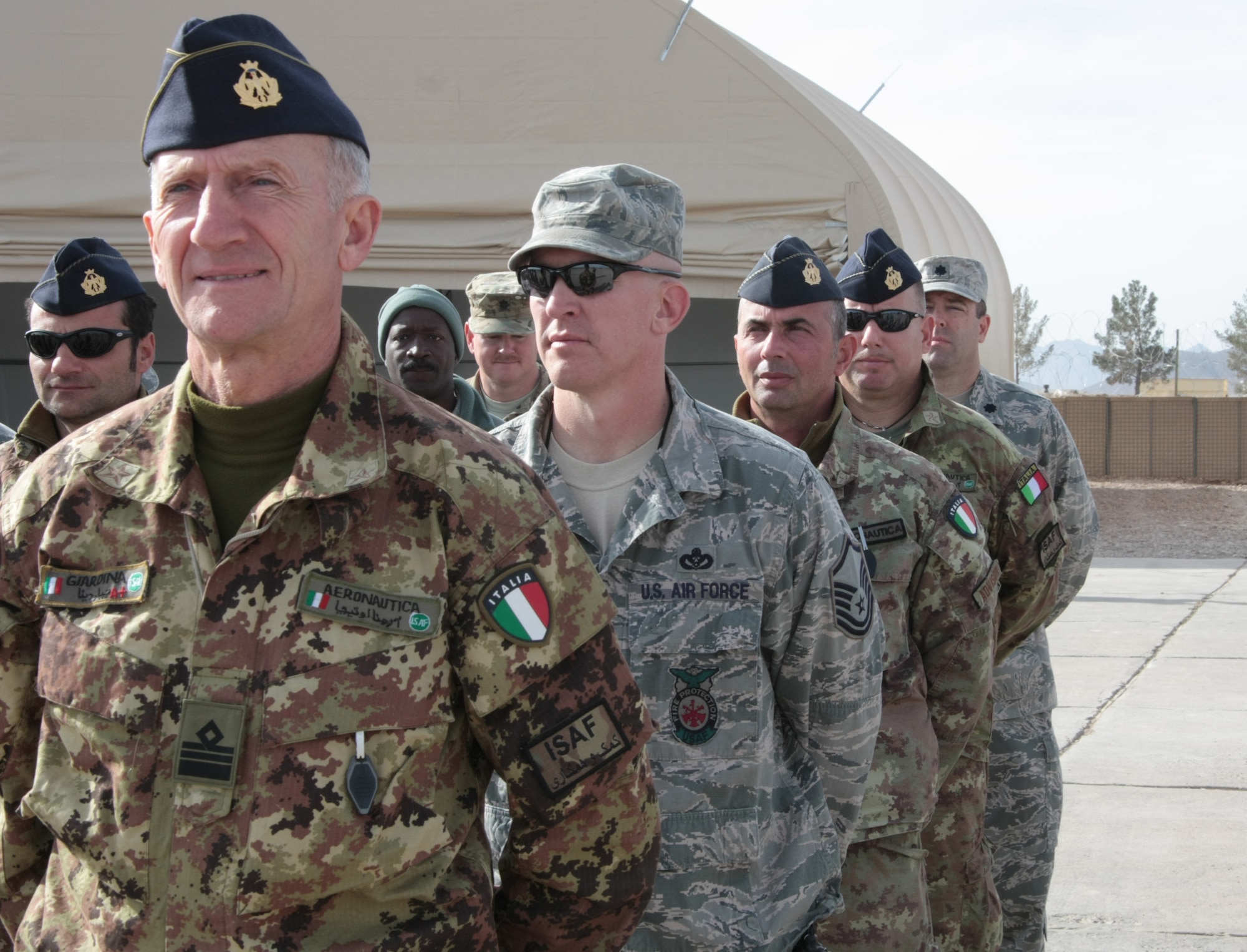 Coalition partners stand in formation at Shindand Air Base Dec. 10 during a ceremony that marked the beginning of the first undergraduate pilot training held exclusively inside Afghanistan in more than 30 years. (Italian air force photo by/OF-2 Cristoforo Russo,)
