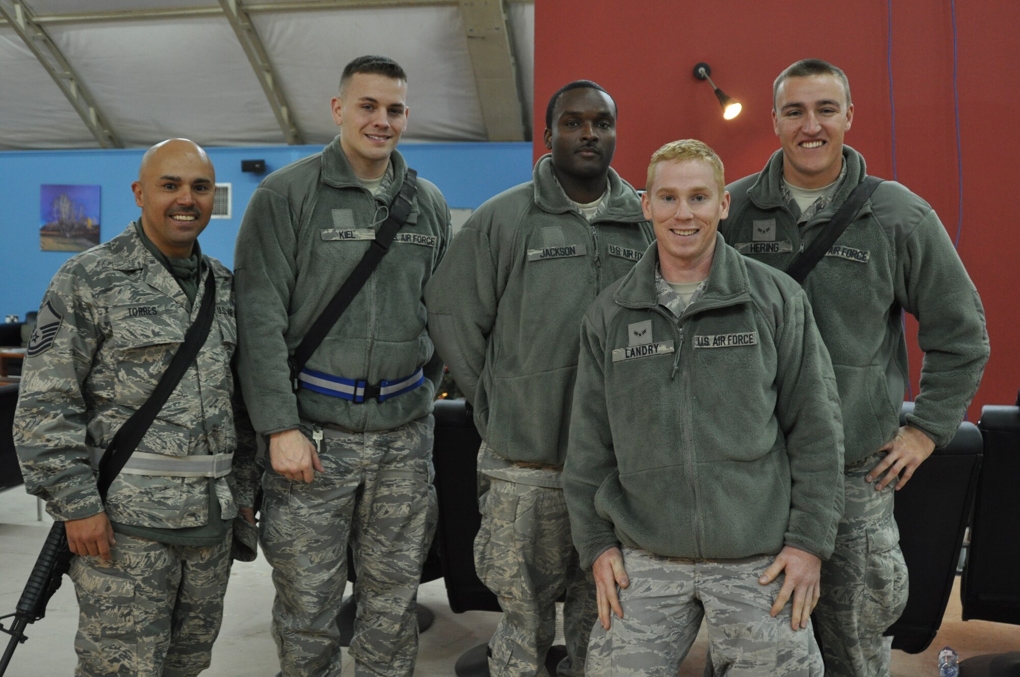 KANDAHAR AIRFIELD, Afghanistan -- From left, Master Sgt. Pedro Torres, Senior Airman Justin Kiel, Staff Sgt. Jamison Jackson, Airman 1st Class Colin Landry, and Airman 1st Class Marcus Hering from the 451st Air Expeditionary Wing gather at USO Kandahar to play a Call of Duty video game against Miami Dolphins players Nate Garner and Charles Clay Dec. 6, 2011. Pro vs. GI Joe and USO collaborated to bring the Airmen together to play the video game against the professional athletes. (U.S. Air Force photo by Capt. Passion Julinsey)
