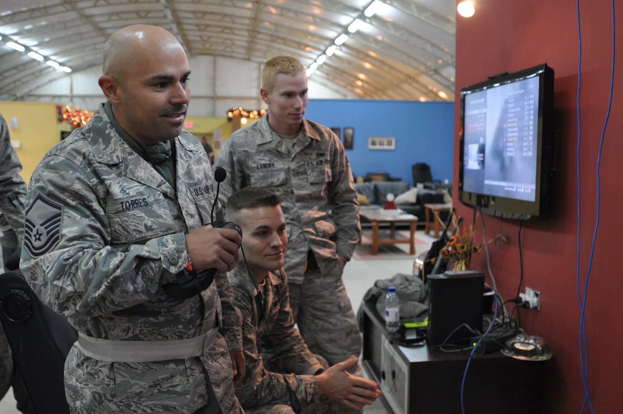 KANDAHAR AIRFIELD, Afghanistan -- Master Sgt. Pedro Torres, 451st Air Expeditionary Maintenance Squadron shop chief, speaks to Miami Dolphins players Nate Garner and Charles Clay at a Pro vs. GI Joe event at USO Kandahar Dec. 6, 2011. Senior Airman Justin Kiel, center, and Airman 1st Class Colin Landry listened to the conversation after finishing a Call of Duty video game with the two professional athletes playing in Davie, Fla. (U.S. Air Force photo by Capt. Passion Julinsey)