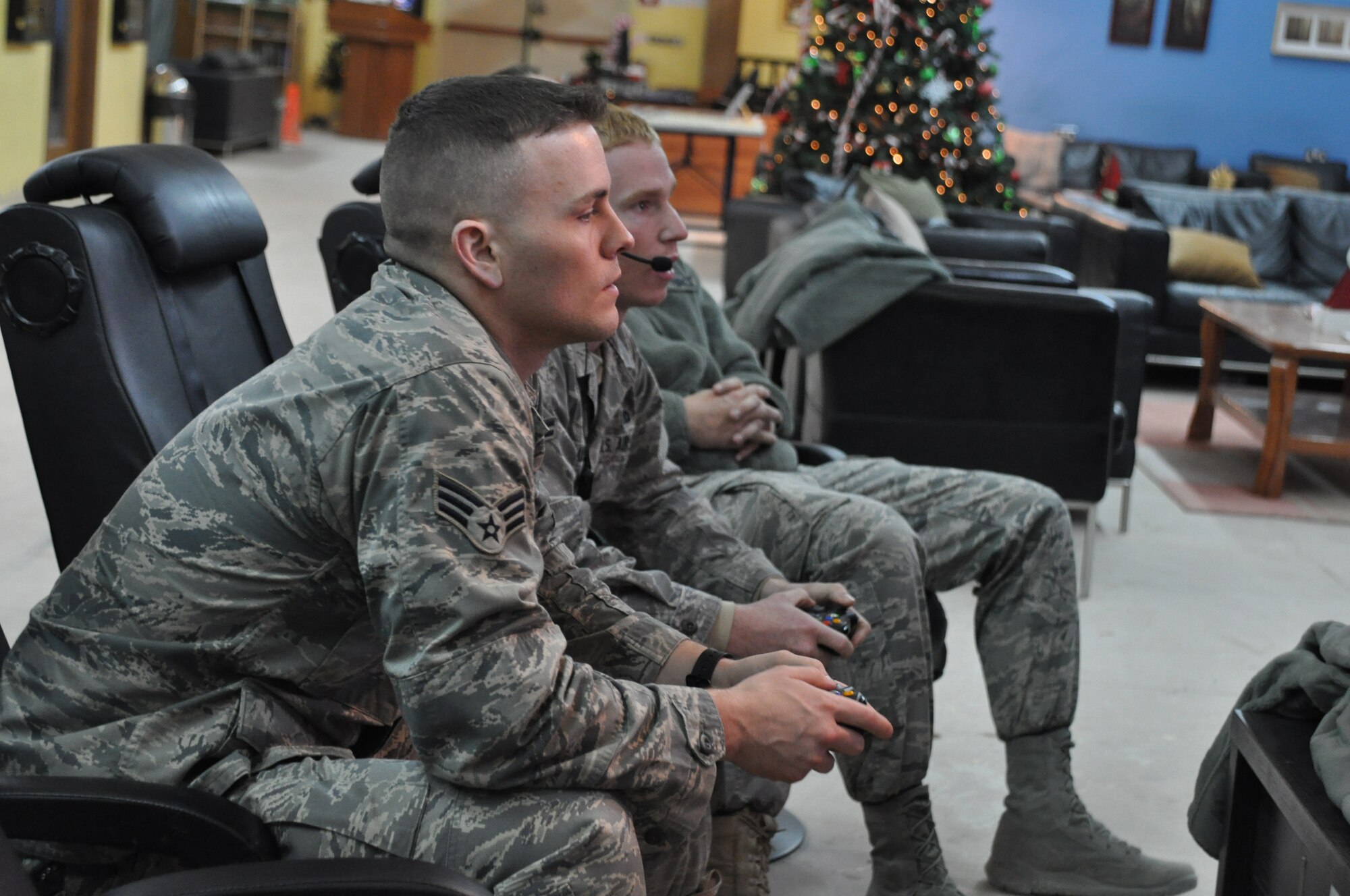 KANDAHAR AIRFIELD, Afghanistan -- Senior Airman Justin Kiel, left, and Airman 1st Class Colin Landry play a Call of Duty video game against Miami Dolphins players Nate Garner and Charles Clay at USO Kandahar Dec. 6, 2011. Pro vs. GI Joe, a nonprofit organization, arranges for deployed service members to play video games with professional athletes. (U.S. Air Force photo by Capt. Passion Julinsey)