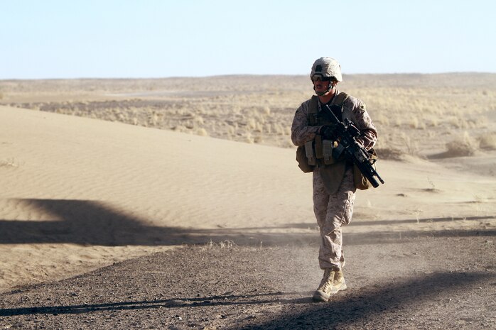U.S. Marine Sgt. Ryan McDowell, a 24-year-old rifleman from Kent, Ohio, moves toward a target during an air interdiction force mission here, Dec. 7. The AIF mission was conducted in support of an Afghan Border Police led clearing operation in Khan-Neshin. During the mission, Marines and sailors from Charlie Co., 1/25, and 2nd Bn., 11th Marines, circled above, searching for suspicious vehicles or personnel. The AIF plays a unique role with Regimental Combat Team 5’s counter-insurgency operations in southern Helmand.