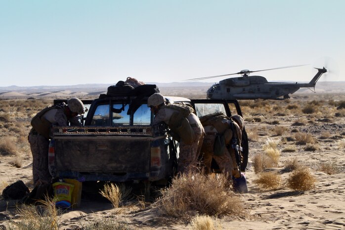 KHAN NESHIN, Helmand province, Afghanistan – U.S. Marines with the air interdiction force composed of 1st Battalion, 25th Marine Regiment, and 2nd Bn., 11th Marines, search a vehicle during an air interdiction force mission here, Dec. 7. The AIF mission was conducted in support of an Afghan Border Police led clearing operation in Khan-Neshin. During the mission, Marines and sailors from Charlie Co., 1/25, and 2nd Bn., 11th Marines, circled above, searching for suspicious vehicles or personnel. The AIF plays a unique role with Regimental Combat Team 5’s counter-insurgency operations in southern Helmand.