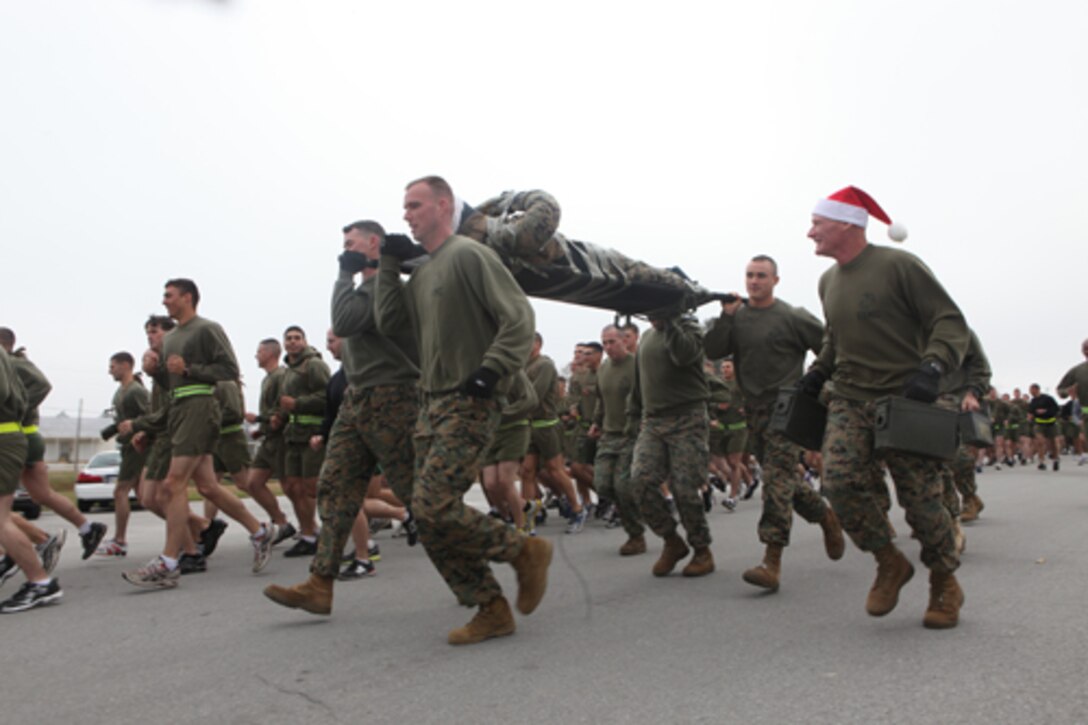 The Marines and families of Advanced Infantry Training Battalion, School of Infantry - East run the two-mile Toys for Tots fun run aboard Camp Geiger, recently. At the conclusion of the fun run, participants cheered the remaining runners and walkers on so they could all enjoy hot beverages and food in the chilling morning weather.