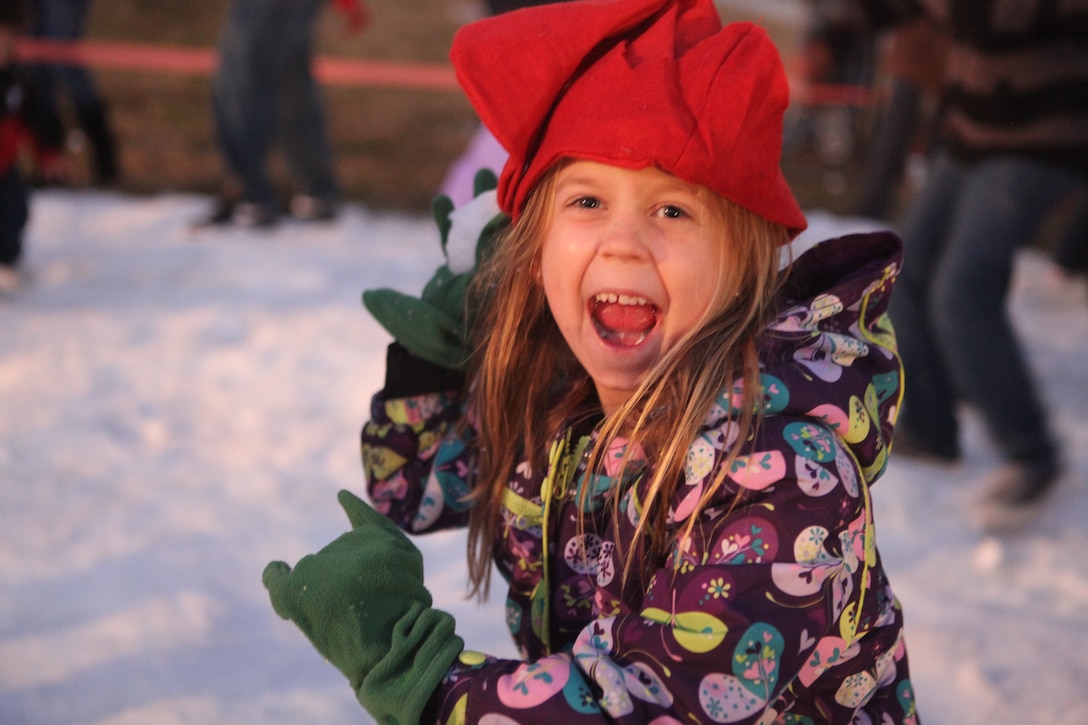 An attendant of the Atlantic Marine Corps Communities HOme for the Holidays event prepares to chuck a snowball in one of the cordoned off snow areas at the AMCC Bicentennial Community Center aboard Marine Corps Base Camp Lejeune, recently.