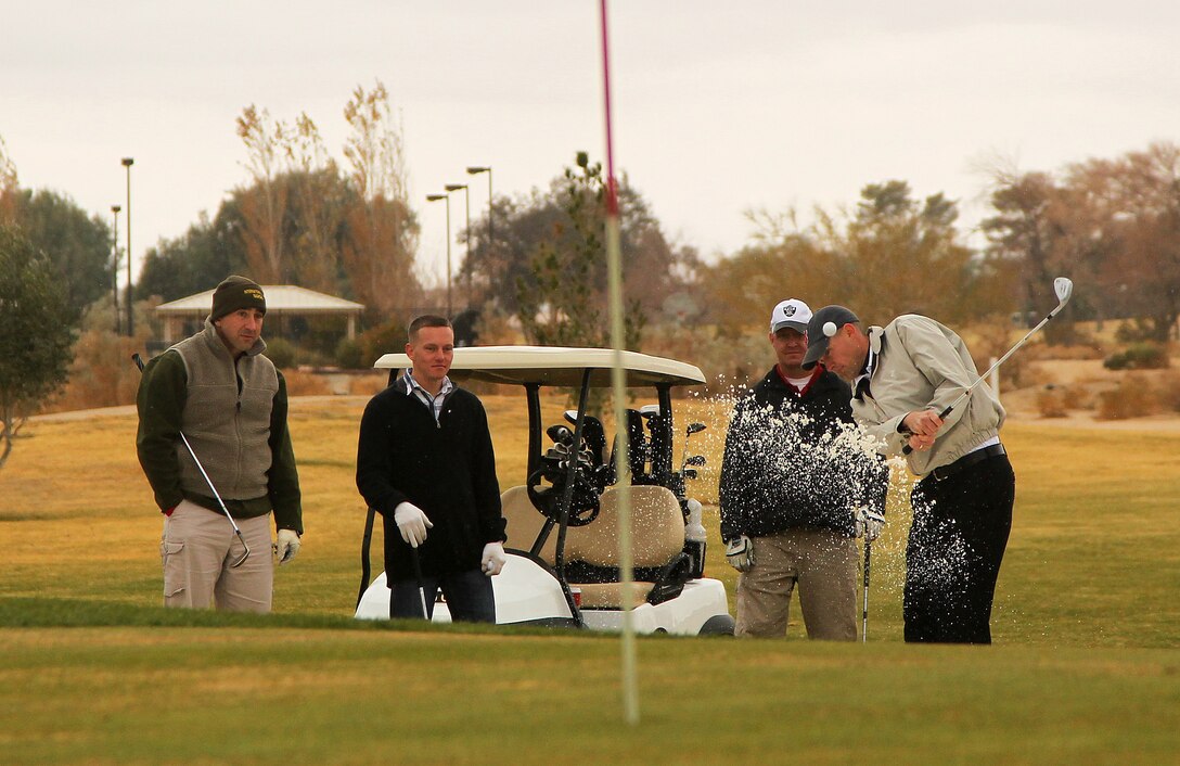 Connor Aucoin drives the ball onto the green during the Commanding General’s Holiday Four-Person Golf Tournament Dec. 13, 2011, at the Desert Winds Golf Course.