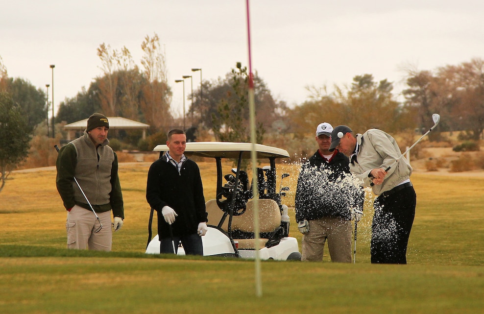 Connor Aucoin drives the ball onto the green during the Commanding General’s Holiday Four-Person Golf Tournament Dec. 13, 2011, at the Desert Winds Golf Course.