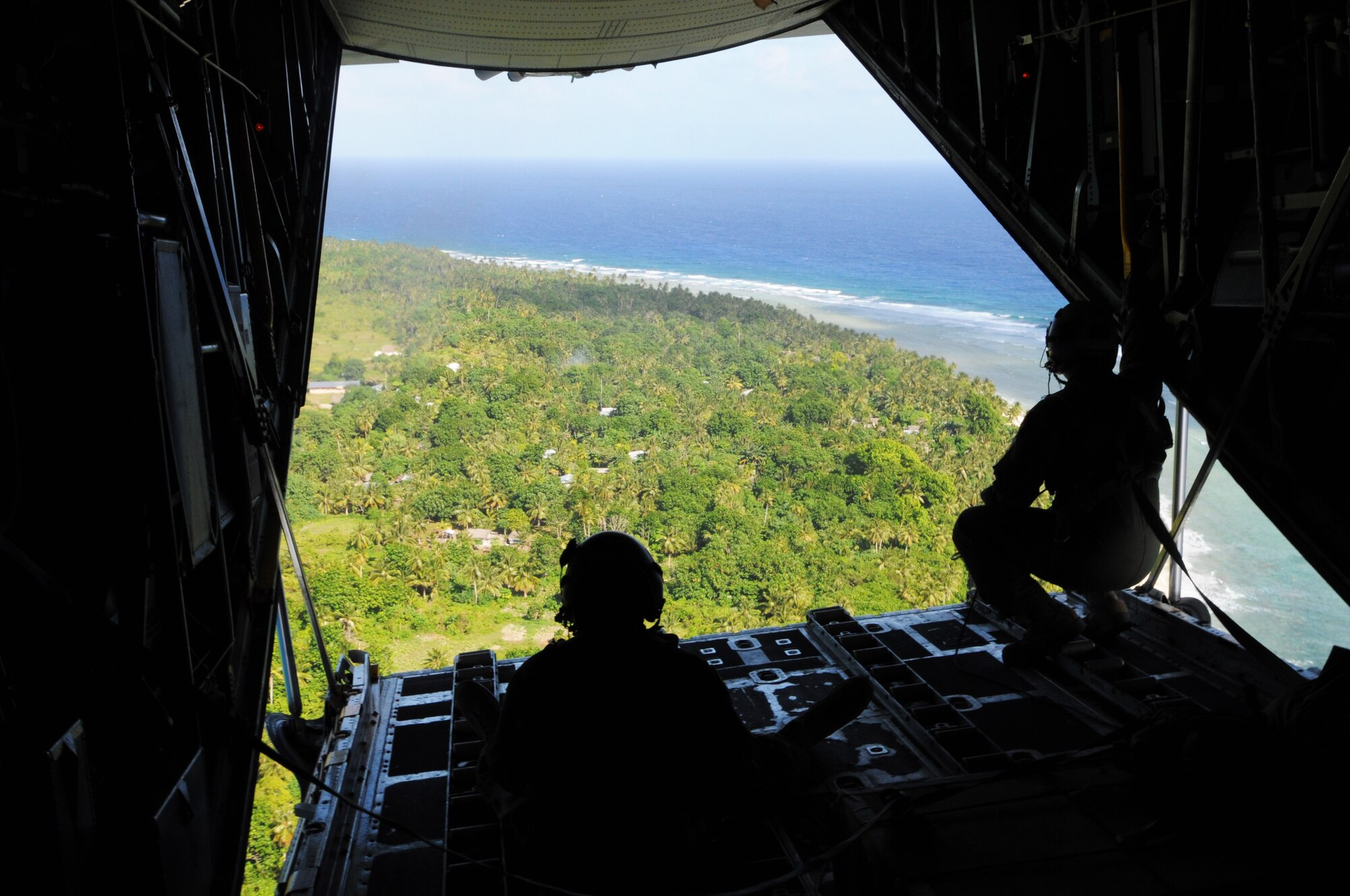 ANDERSEN AIR FORCE BASE, Guam - The view out the back of a C-130 Hercules during Operation Christmas Drop, Dec. 12.  The island of Fais is located within the Yap state of the Micronesian Islands and is one of the more than 50 islands that will receive care packages this holiday season as part of OCD. (U.S. Air Force photo/Senior Airman Carlin Leslie)