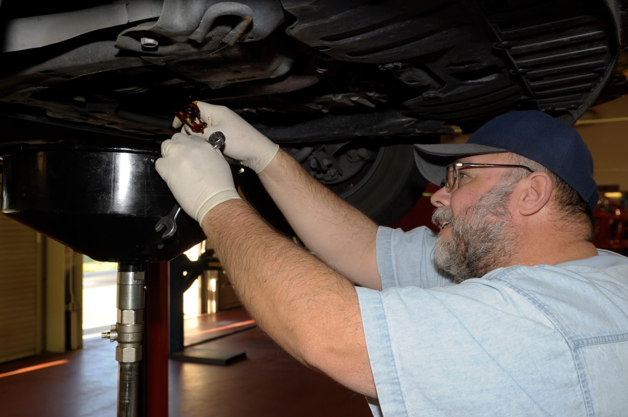 VANDENBERG AIR FORCE BASE, Calif. -- Eric Whittaker, a United Paradine contractor, drains the oil from his car into a recovery container during an oil change at the auto hobby shop here Friday, Dec. 9, 2011. The auto hobby shop is open to customers with base access offering a variety of services and a knowledgeable staff to help with automotive projects.
(U.S. Air Force photo/Jerry E. Clemens Jr.)