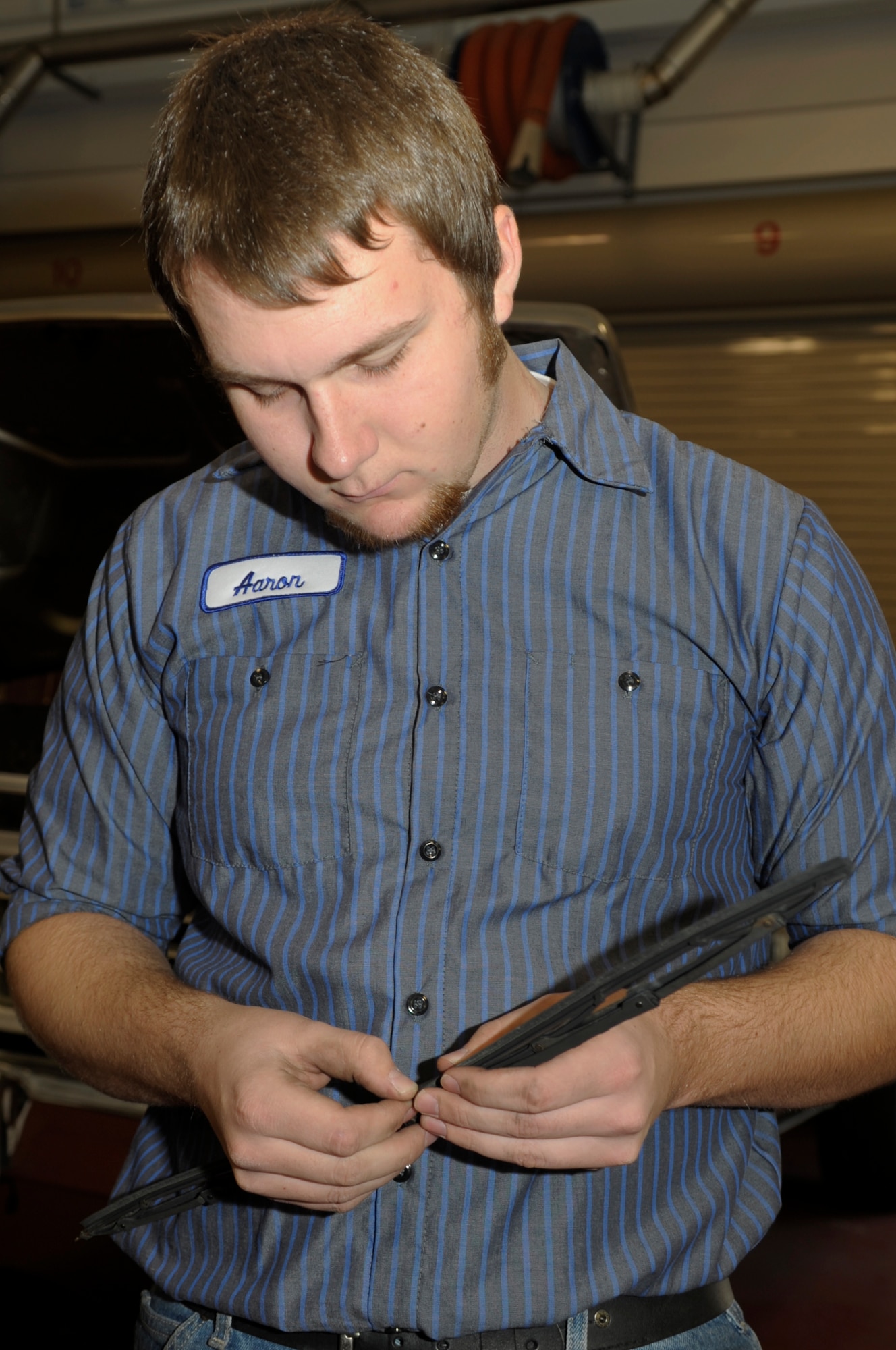 VANDENBERG AIR FORCE BASE, Calif. -- Aaron Moreheart, an automotive specialist, inspects a windshield wiper blade at the auto hobby shop here Friday, Dec. 9, 2011. The auto hobby shop is open to customers with base access offering a variety of services and a knowledgeable staff to help with automotive projects. 
(U.S. Air Force photo/Jerry E. Clemens Jr.)