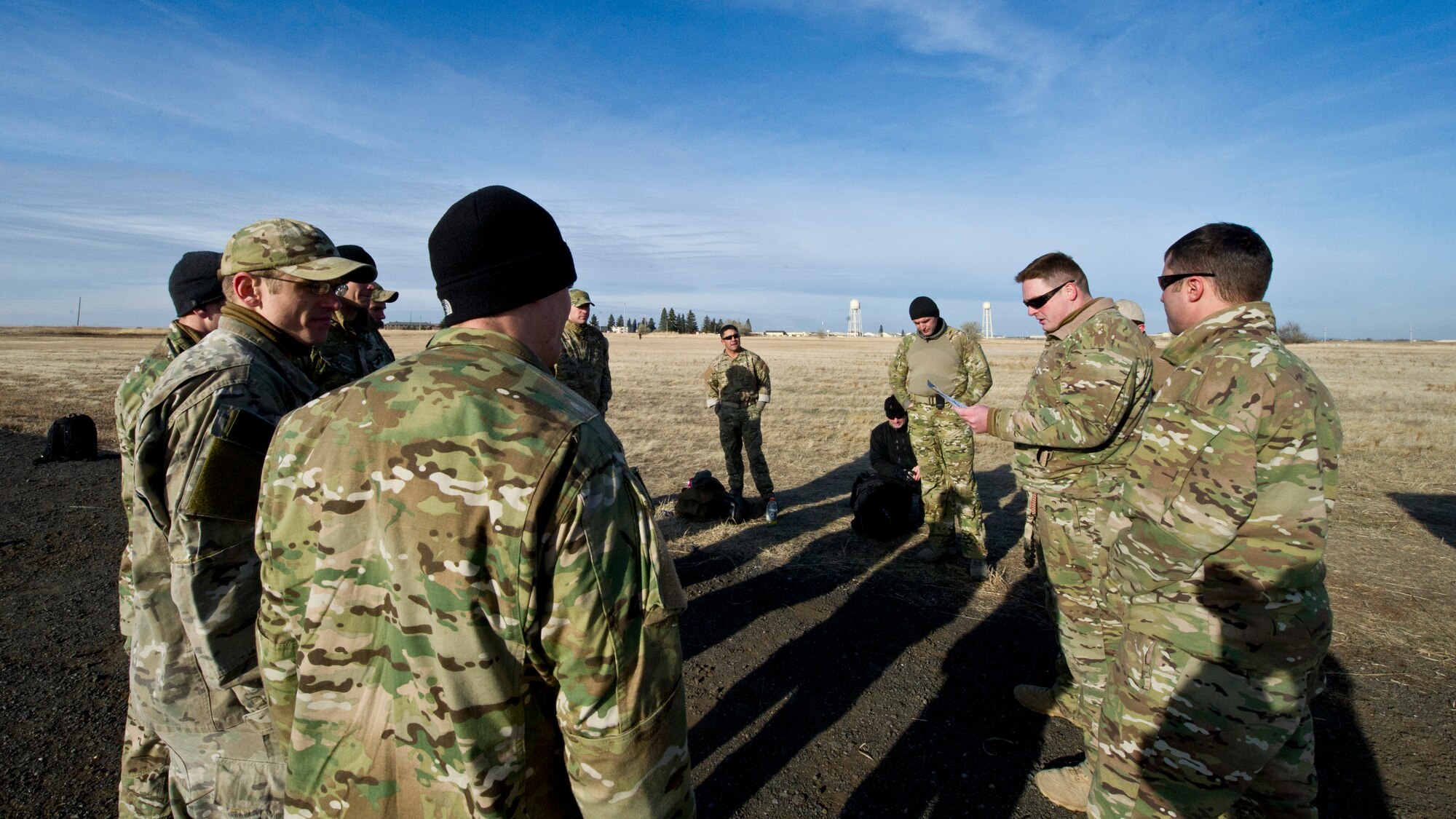 Tech. Sgt. Justin McCaffrey, SERE specialist, gives the end of mission debriefing to students of the static line and free-fall jump courses, after completing the training for the day at Fairchild Dec. 5. (U.S. Air Force photo/Airman 1st Class Taylor Curry)