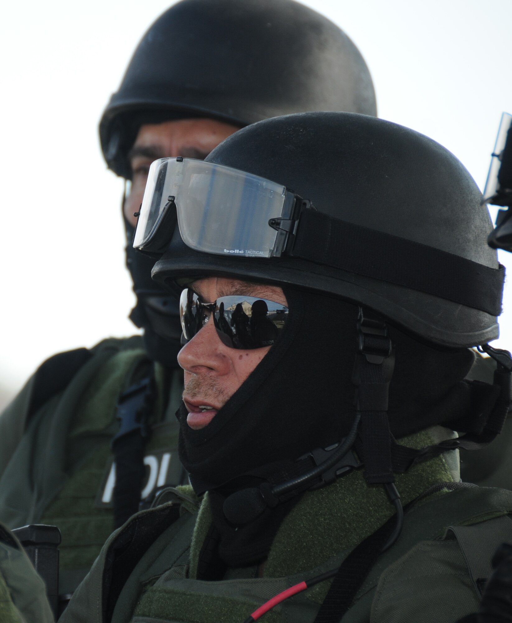 During an anti-hijacking exercise on the flightline at Keesler Air Force Base, Miss., Dec. 12, 2011, Biloxi Police Department Special Response Team members Officers Frank Taranto and David Bell listen as the operations brief is being provided by their team leader.  (U.S. Air Force photo by Kemberly Groue)