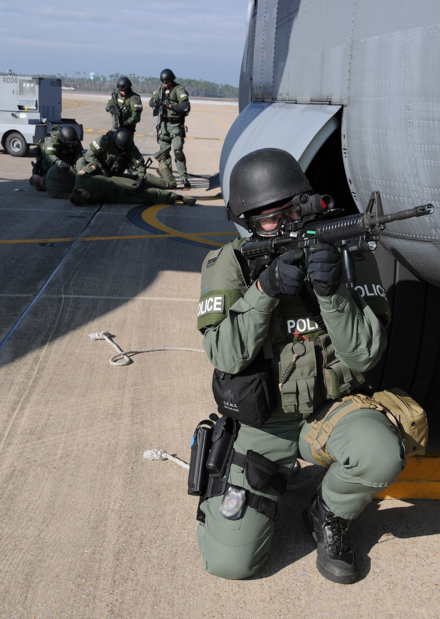 During an anti-hijacking exercise on the flightline at Keesler Air Force Base, Miss., Dec. 12, 2011, Officer Kris Hines, Biloxi Police Department Special Response Team, provides flank security for his team as they secure the aircraft and it’s passengers during the exercise.  (U.S. Air Force photo by Kemberly Groue)