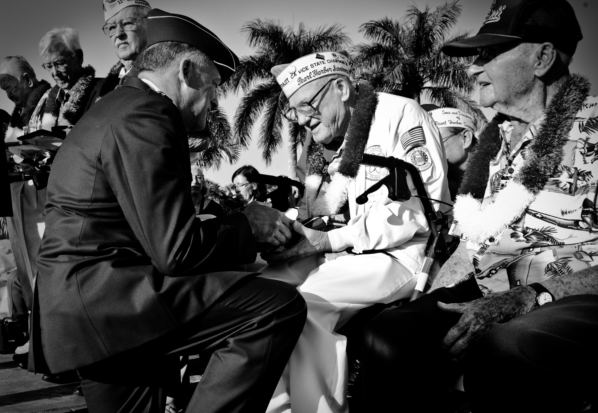 Gen. Gary North, Pacific Air Forces commander, presents Frank Karas, a Hickam Field survivor of the 1941 attacks on Oahu, with a folded U.S. flag during the 70th Anniversary Remembrance Ceremony at Joint Base Pearl Harbor-Hickam, Hawaii, Dec. 7, 2011. Karas was a buck private in 1941, and asleep in bed when the Japanese attacked. Karas’s decision to sleep in instead of going to the chow hall for breakfast the morning of the attacks was a decision he believes saved his life. (U.S. Air Force photo/Senior Airman Lauren Main/Released)