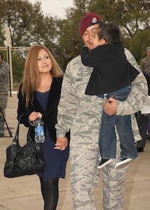 Tech. Sgt. Luis Garcia, with his wife, Brenda, son Mayan and daughter Zinnia (not pictured) arrive for the Bronze Star Medal with Valor presentation Dec. 2. (U.S. Air Force photo/Robbin Cresswell)